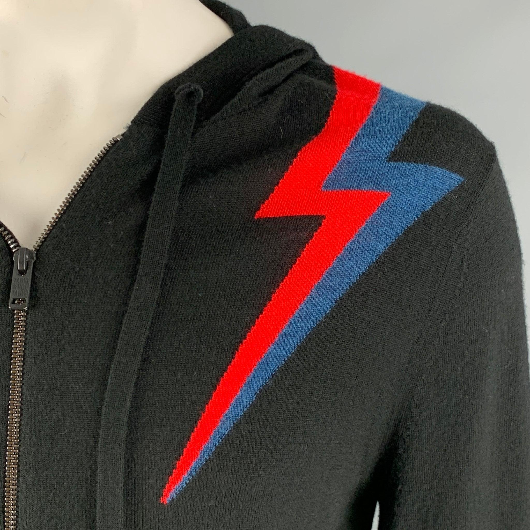 ZADIG & VOLTAIRE hoodie cardigan in a lightweight black merino wool fabric featuring red and blue lightning bolt color block design, and a zip up closure.Very Good Pre-Owned Condition. Moderate signs of wear. 

Marked:   L 

Measurements: 
