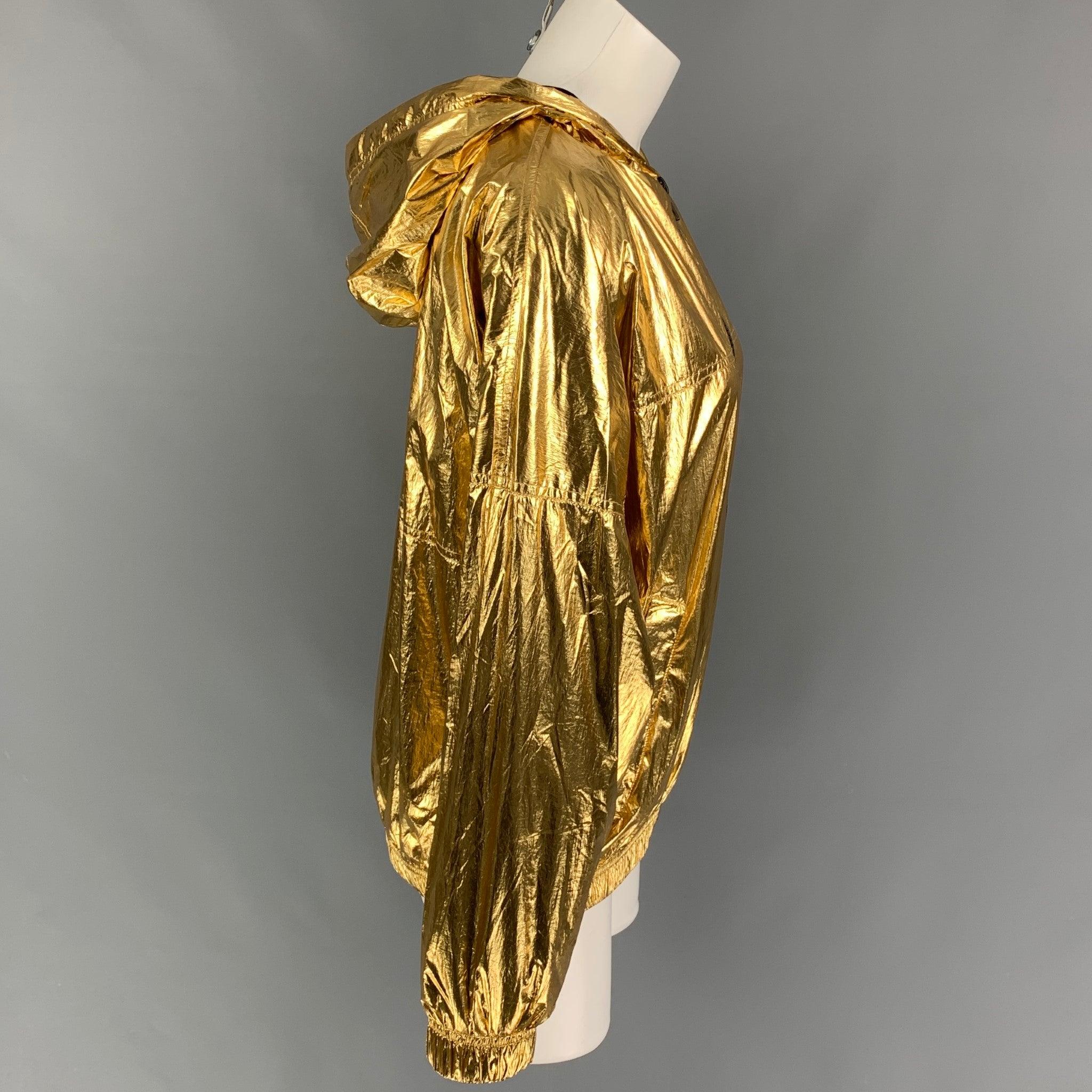 ZADIG & VOLTAIRE jacket comes in a gold metallic polyamide featuring a loose fit, hooded style, slit pockets, elastic hem, and a full zip up closure.
New With Tags.
 

Marked:   36 

Measurements: 
 
Shoulder: 17 inches  Bust: 46 inches  Sleeve: 17