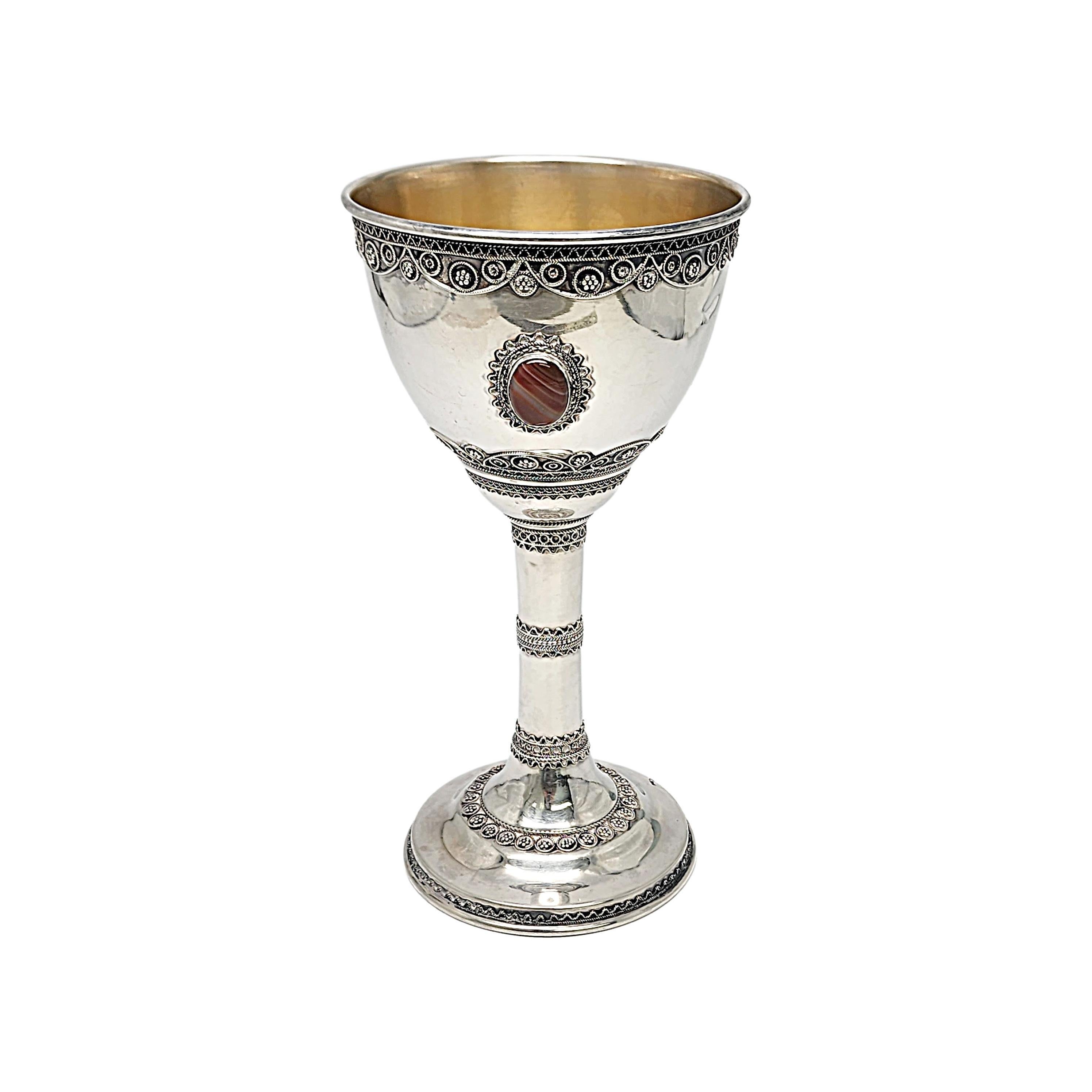 Sterling silver with gold wash interior 3 stones tall kiddush cup goblet by Zadok of Israel.

No monograms or engraving.

With a gold wash cup interior, this large cup/goblet features 3 bezel set stones and ornate filigree design accents. The stones