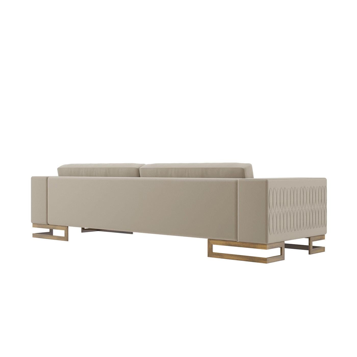 This sophisticated three-seater sofa is defined by sleek geometric lines, boasting a sturdy multi-layer frame crafted from poplar and spruce. Its waterproof and stain-proof beige velvet upholstery is detailed with oval-shaped quilting on the arms,