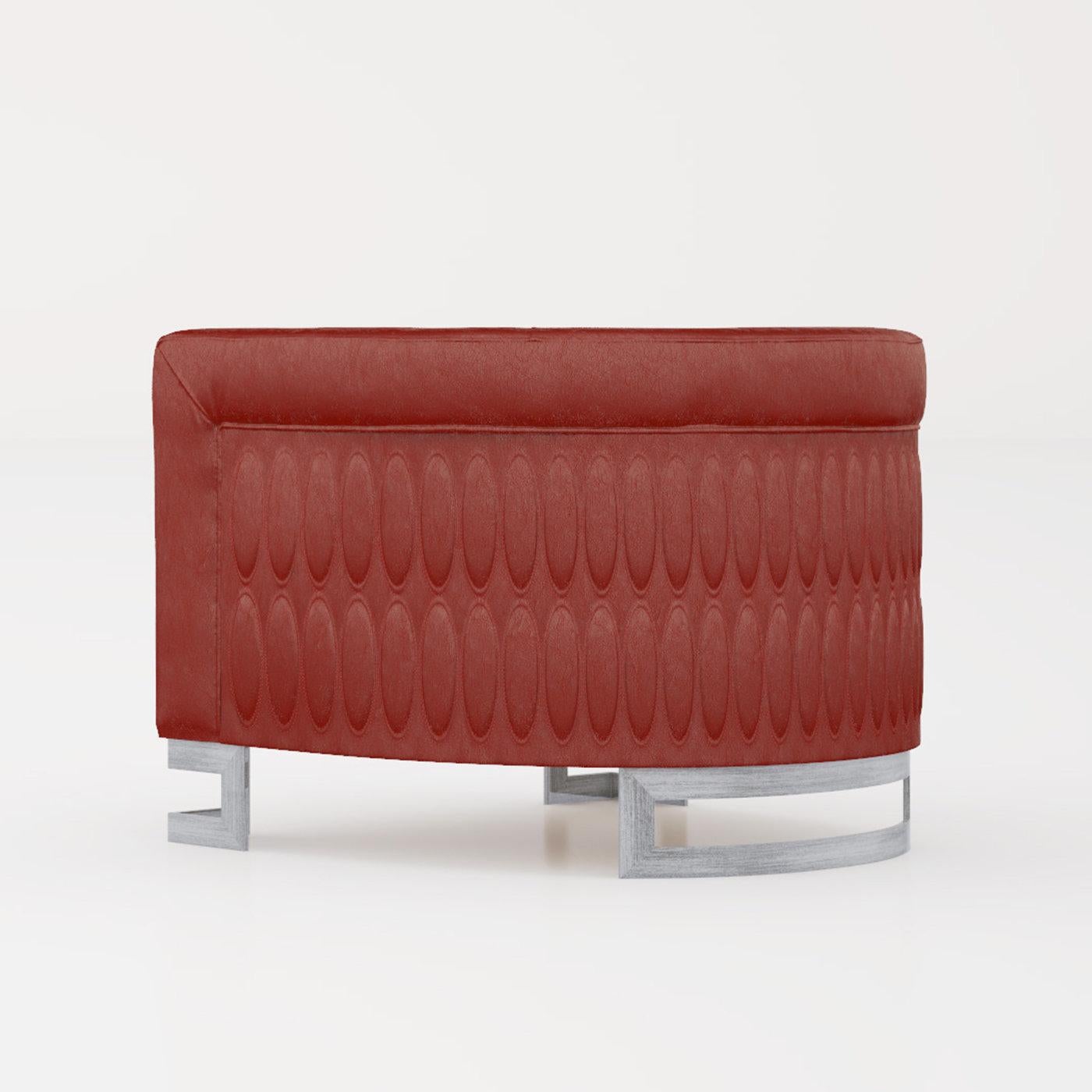The Zaffiro red armchair makes a luxurious addition to any contemporary living space. Its solid poplar and spruce frame is fully upholstered in smooth red leather, paired with polished brushed nickel feet. Finished with oval quilting on the sides as