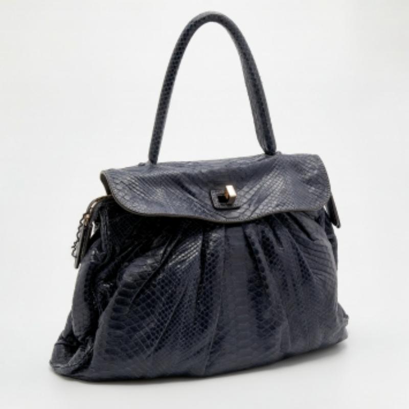 Know for their exquisite craftsmanship and timeless designs, Zagliani bags are a must-have. This Procida bag is made from blue python skin, which is embellished with gold-tone hardware. It showcases a single handle and a suede-lined interior. This