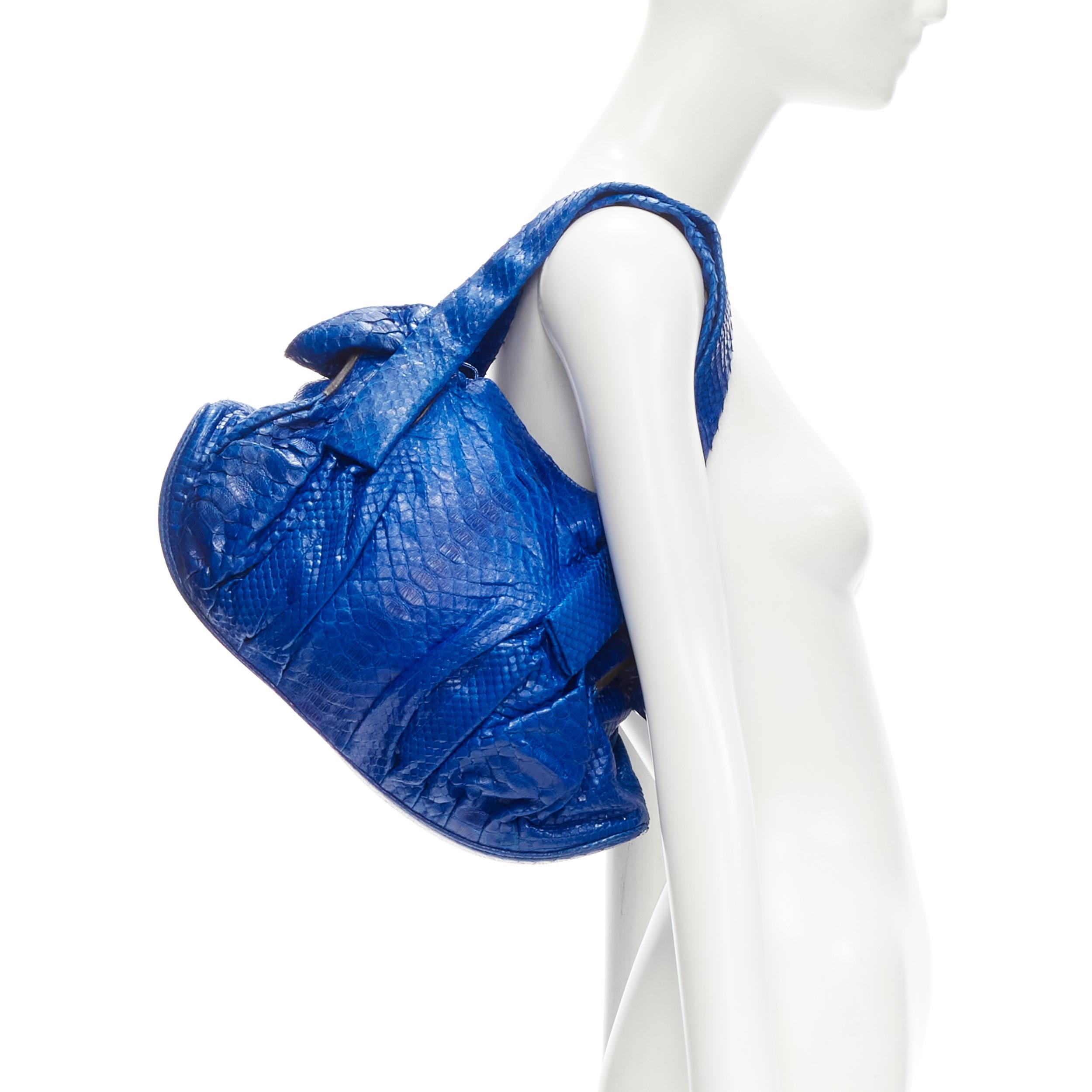 ZAGLIANI cobalt blue scaled leather dumpling top handle bag
Brand: Zagliani
Extra Detail: Soft unstructured scaled leather. Gathered side. Curved base dumpling shaped. Magnetic opening. Wall zip compartment and phone pocket at