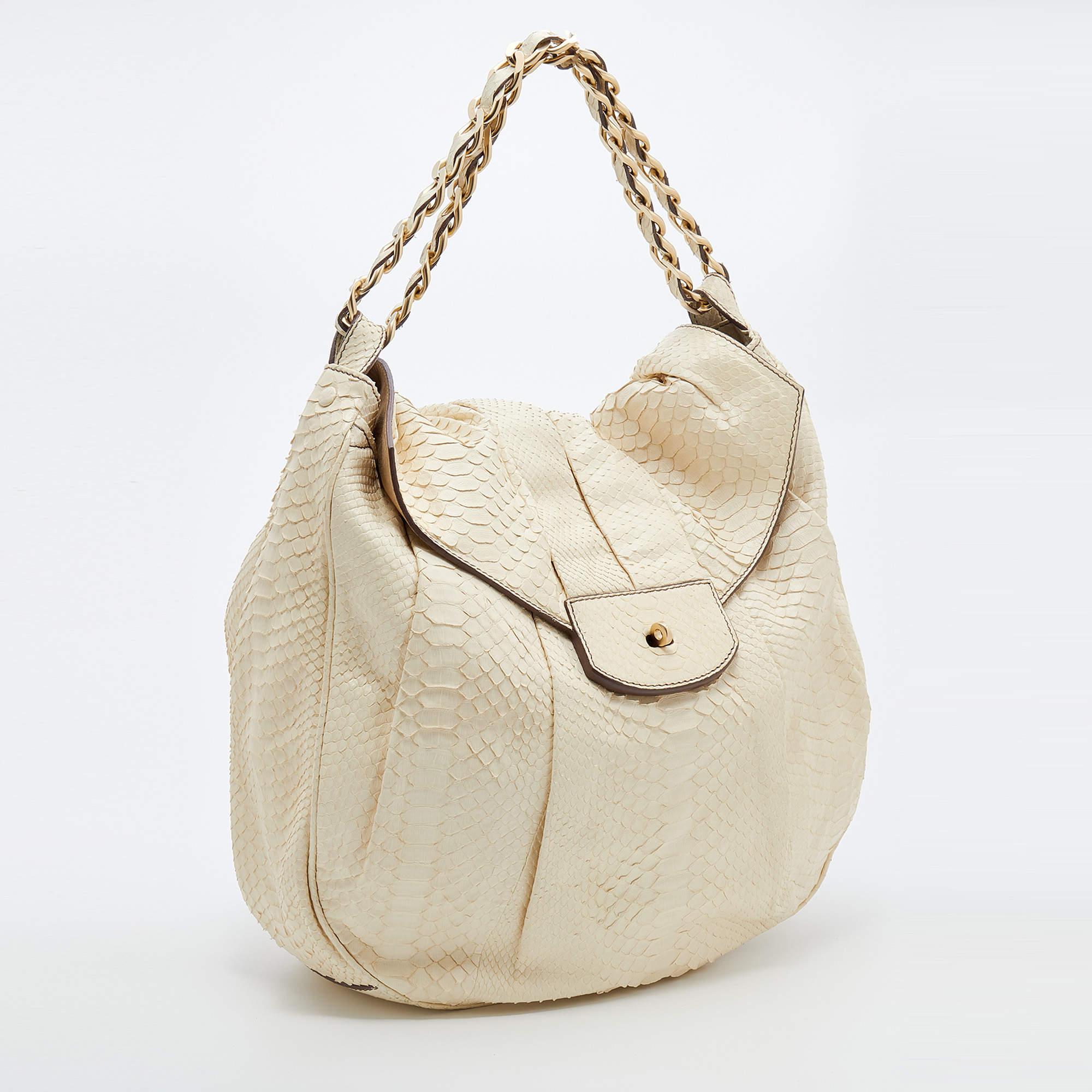 Swing and twirl in every stride and let your audience gasp in admiration at the beautiful sight of this Zagliani hobo. We rarely get to see a bag as gorgeous as this one. It has been crafted from python and lined with suede on the insides. The bag