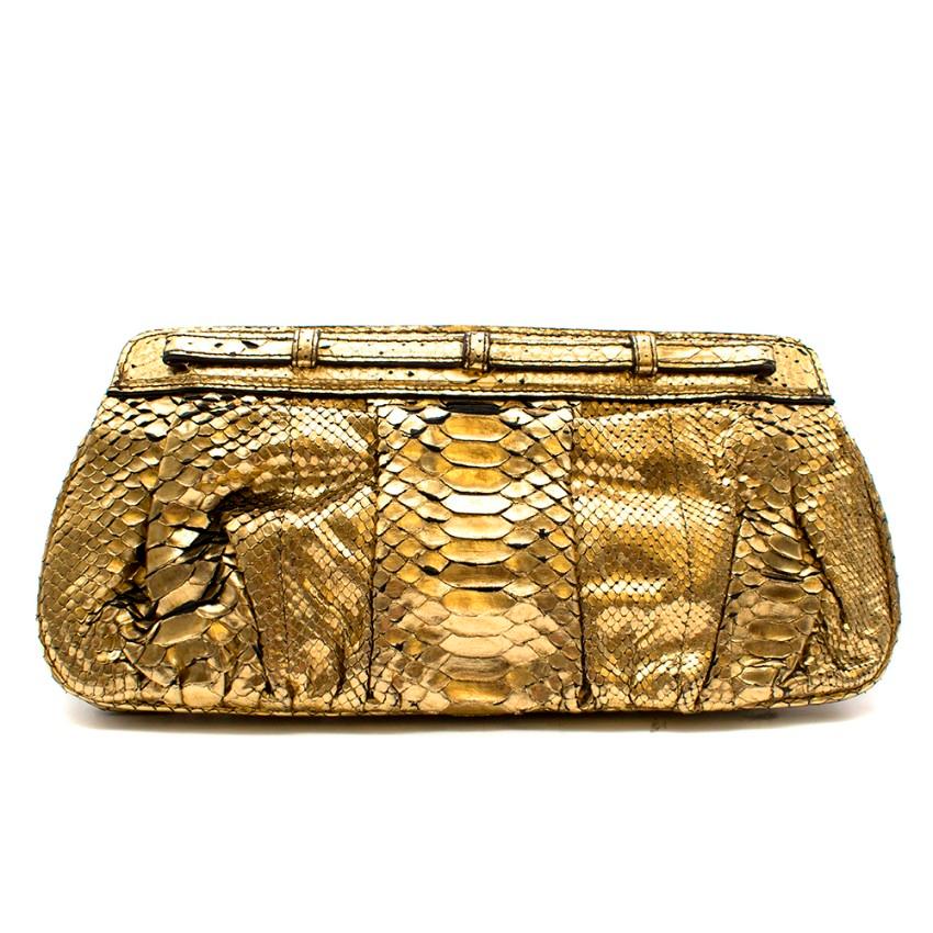 Gold Zagliani Python Clutch

- Python leather
- Metallic
- Gold-tone hardware
- Twist lock closure
- 2 compartments
- Zagliani embossed logo sewn inside the back of bag

Materials
Python Leather

Made in Italy 

Please note, these items are