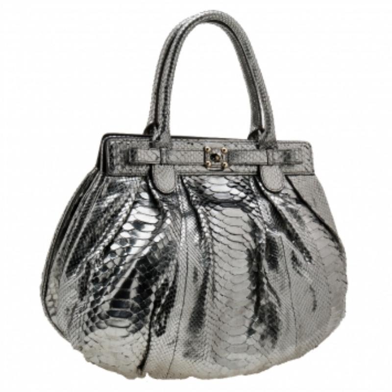Make a fine investment with this Zagliani hobo. It has been skillfully crafted using python leather and is lined with leather on the insides. It has gold-tone hardware and two top handles for you to parade it easily. The metallic silver shade