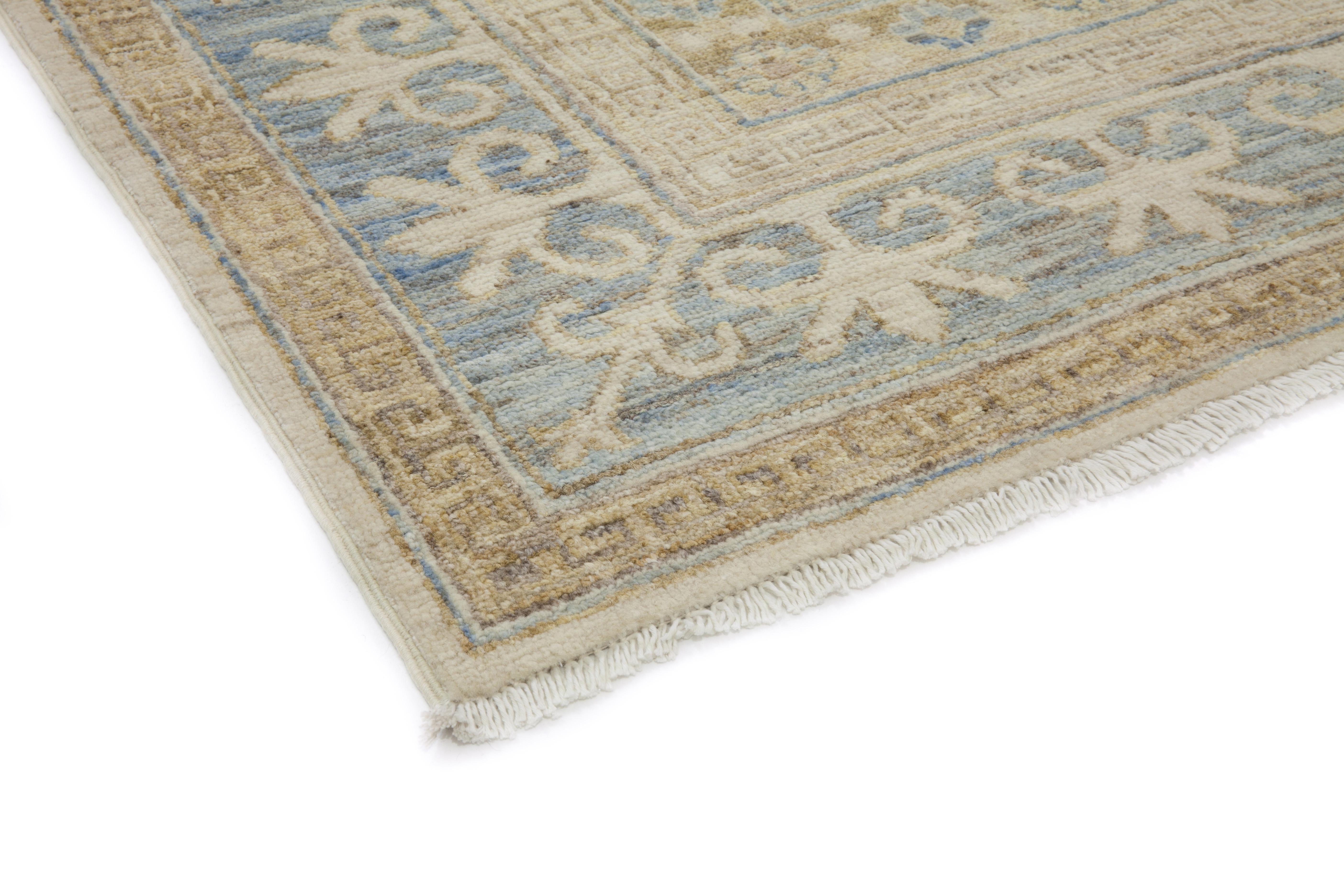Color: Beige - Made In: Pakistan. 100% Wool. The city of Khotan was a key trading post along the Silk Road, and the rugs woven there for centuries incorporated Chinese, Persian, and Western influences. Hand-knotted of soft, durable wool, this