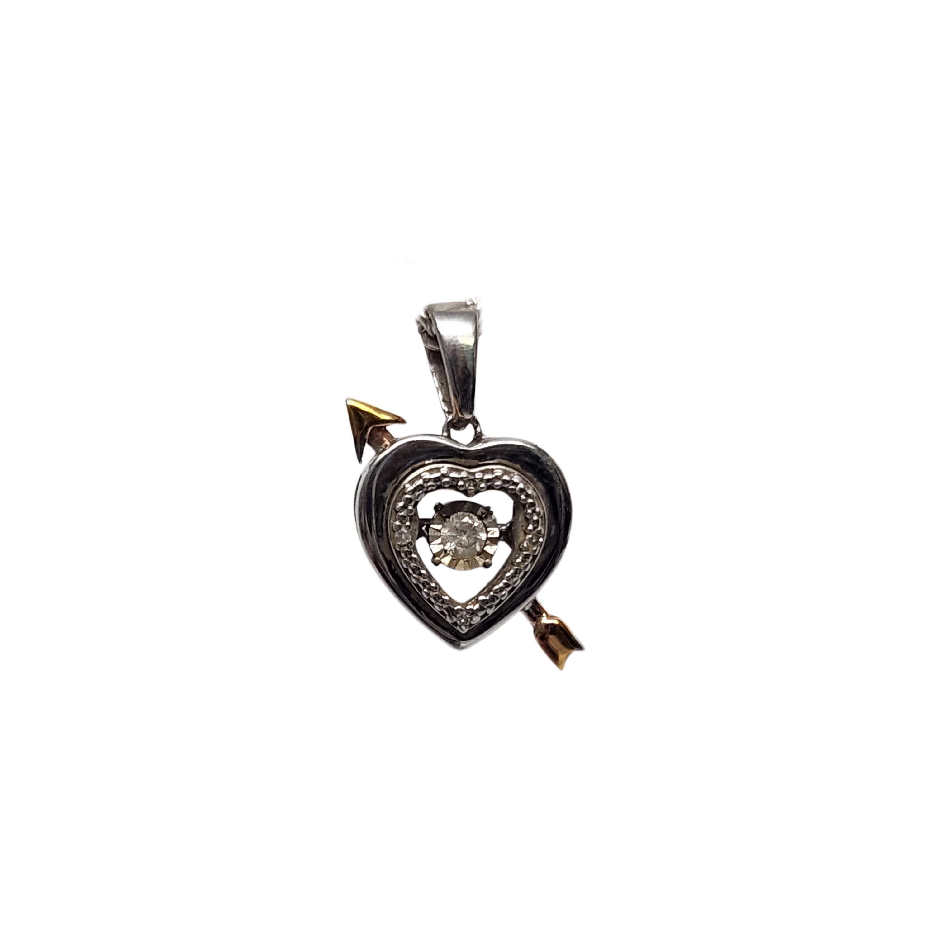 Sterling silver and diamond Unstoppable Love heart and arrow pendant by Zales.

Small open heart,14K gold plated arrow, small round diamond at the center. The diamond looks suspended and moves back and forth.

Weighs approx 1.4g, 0.9dwt

Measures