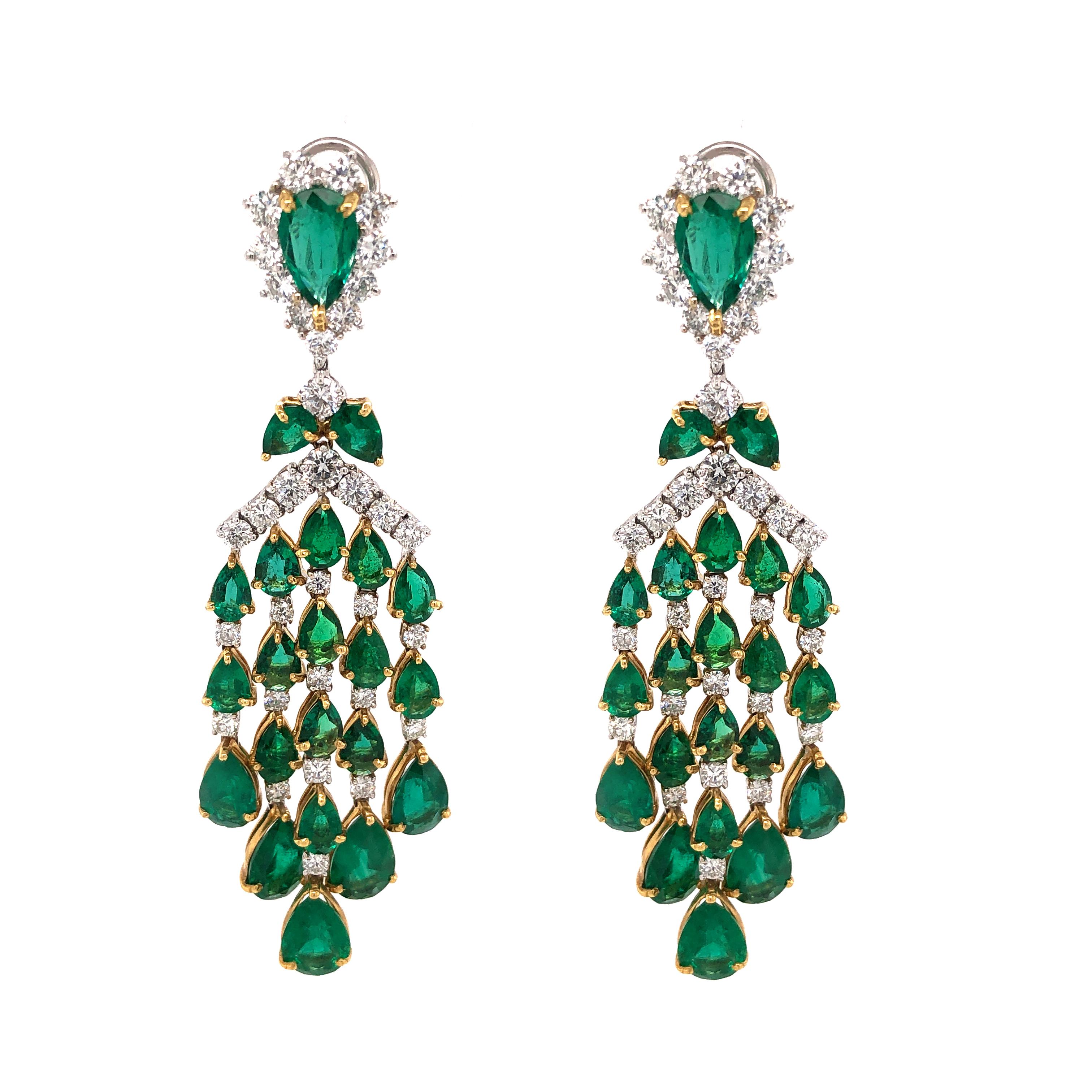 Handcrafted chandelier 18 karat white gold earrings.
Adorned with pear cut emeralds 23.82 ct from Zambia.
Accented with small round diamonds 5.42 ct. 
Diamonds are all natural and white in G-H Color Clarity VS.
French / Omega Clips.
Width: 2.5