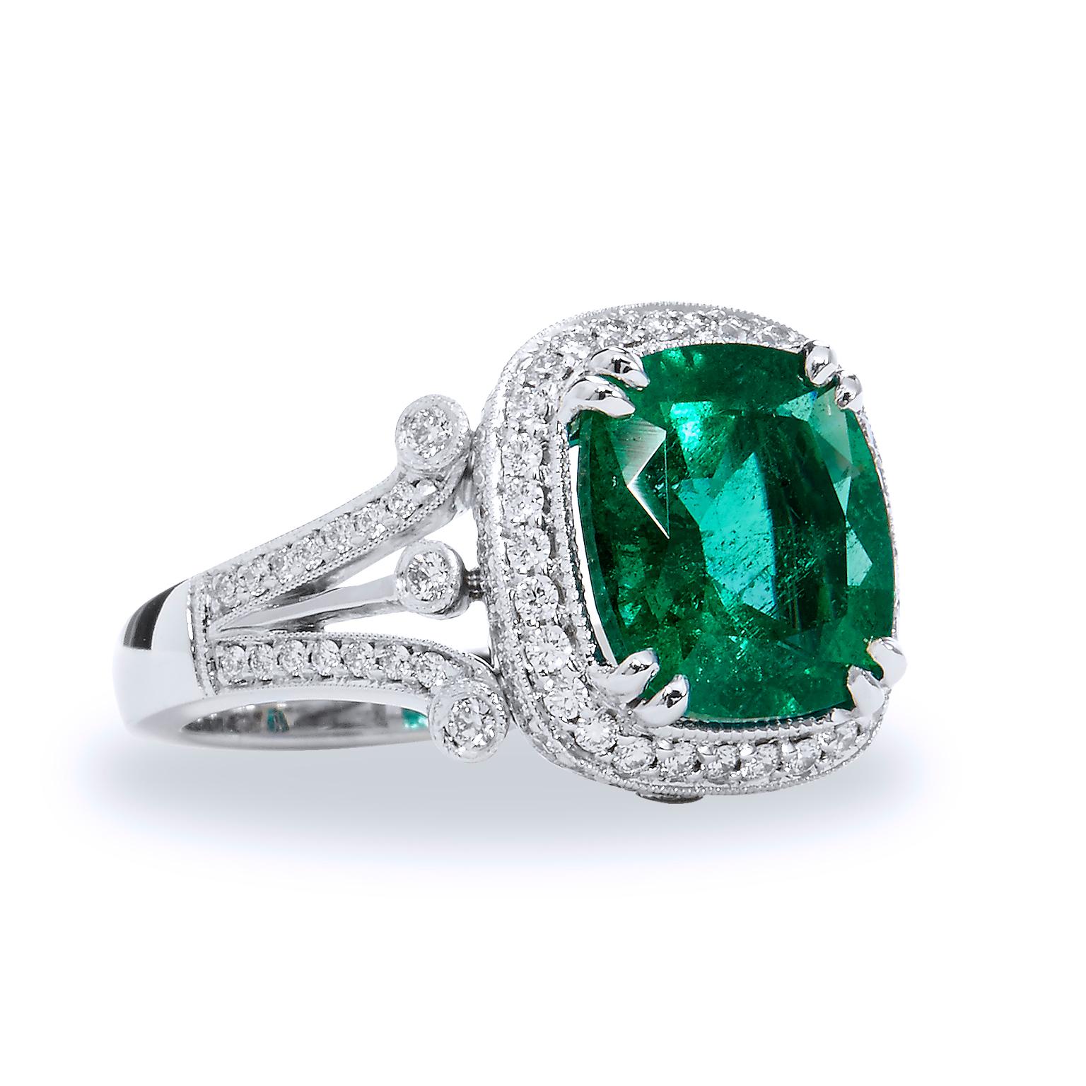 Zambian Cushion Cut Emerald Diamond Ring

This stunning emerald and diamond ring is handmade and one of a kind. 
The center stone is a 4.09 carat Zambian emerald. 
It is surrounded by 100 pieces of 0.7 carat diamonds that are G/H in color and VS in