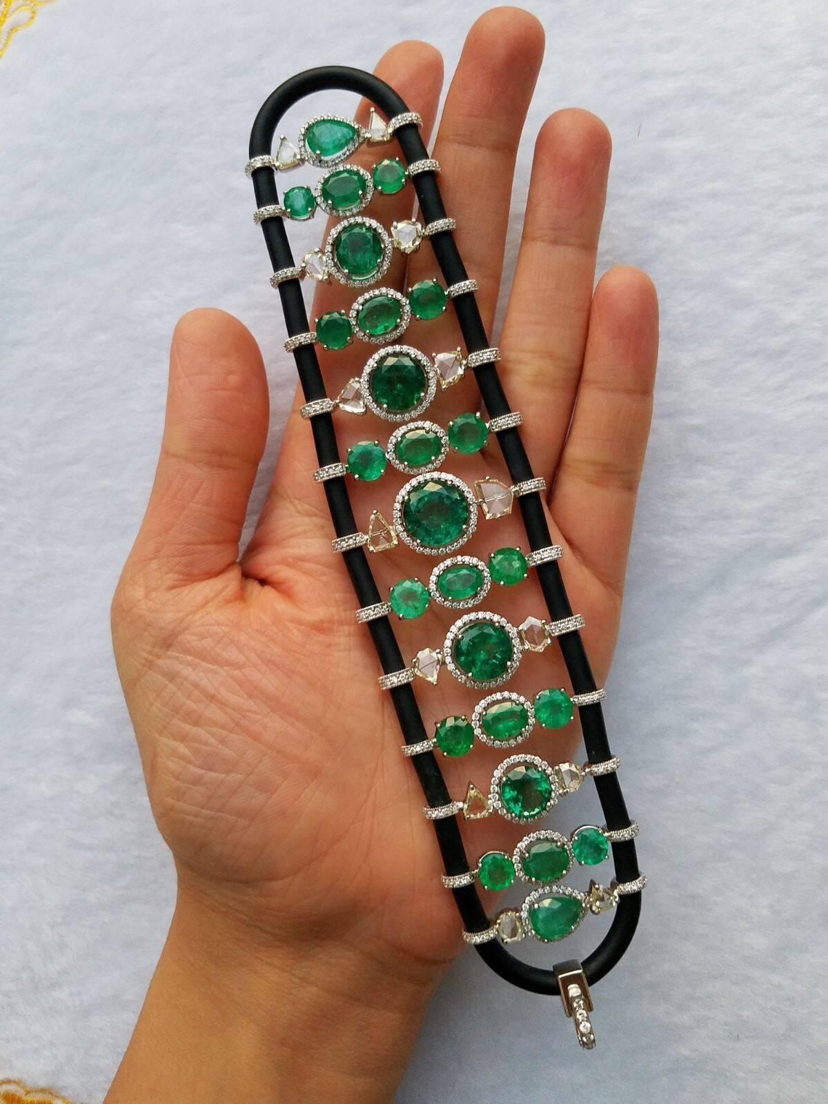 A unique, and contemporary looking rubber bracelet, embelished with Zambian Emerlad and rose cut and fulll cut Diamonds, all set in 18K white gold. 

Stone Details:
Stone: Zambian Emerald
Weight: 41.5 carats
Cut: Pear/Oval/Round

Diamond