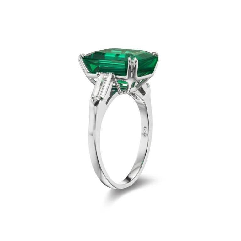 ZAMBIAN EMERALD AND DIAMOND RING Amid these 2 bullet shaped flossy diamonds sits a massive dark hued forest green 7 ct Zambian Emerald and rejuvenates this ring to life Item: # 03362 Metal: Platinum Lab: C.dunaigre Color Weight: 7.28 ct. Diamond