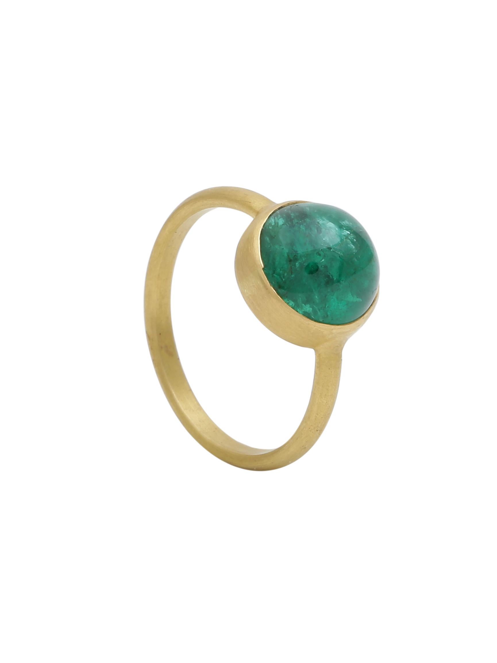 A nice quality Round Zambian Emerald Cabochon handcrafted into a ring in 18K yellow gold in matte finish. The finish of the gold compliments the colour of the emerald making it more vivid. Wear it everyday as a solo ring or stack it with other
