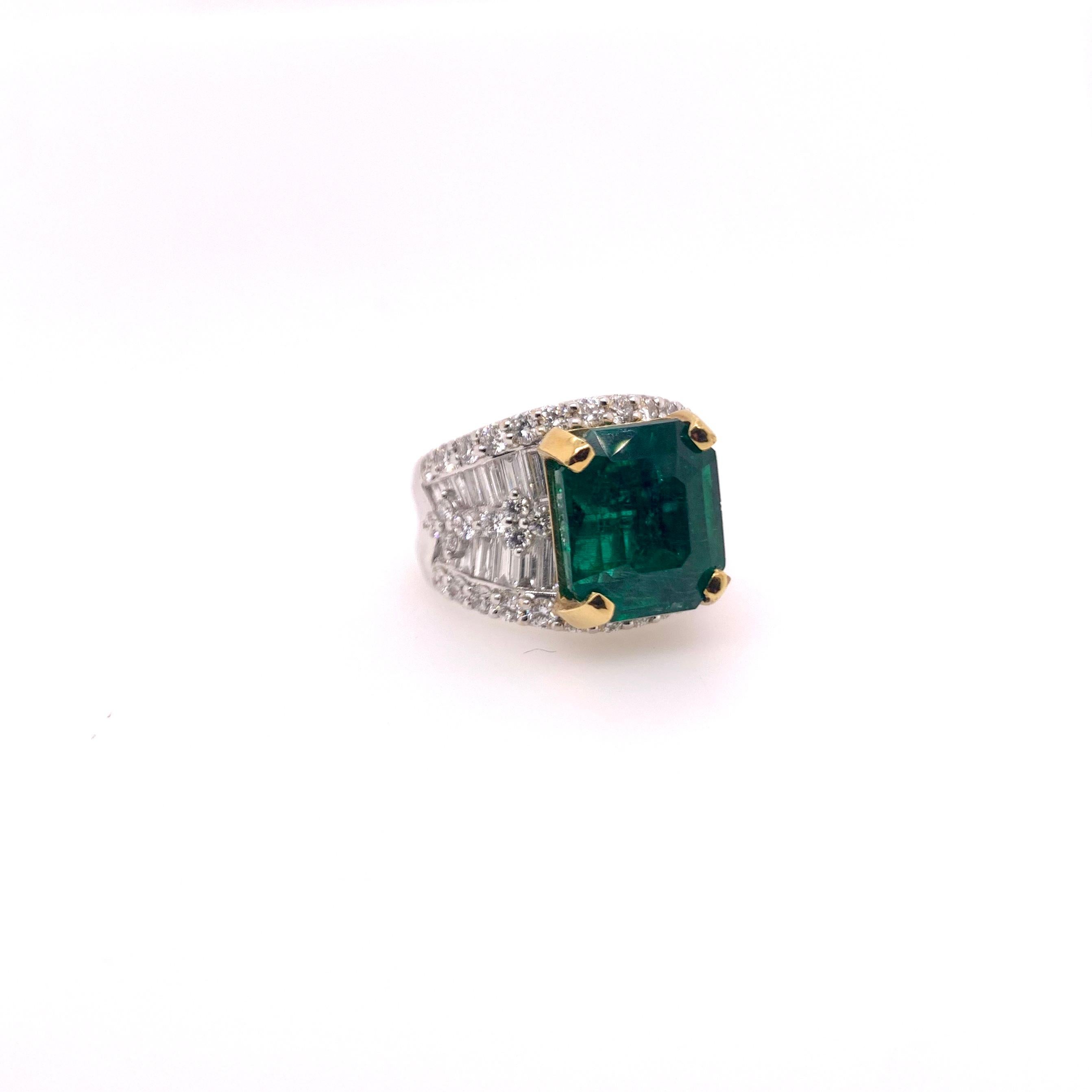 Amazing forest hunter green colored Zambian emerald is set in a custom two tone mounting with diamonds.  The emerald is a lush, color saturated green and is held in place by 18k yellow gold prongs.  The rest of the ring is tailored made with round