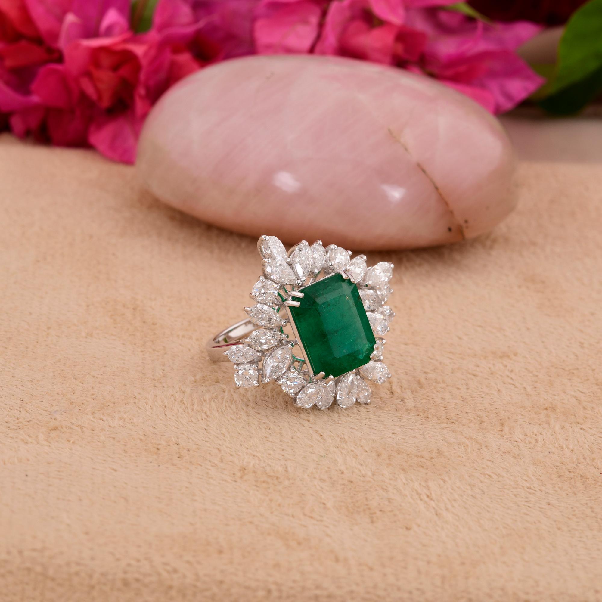 Crafted with meticulous attention to detail, the ring features a handcrafted setting in luxurious 14 Karat White Gold, adding a touch of understated elegance to the design. The polished gold complements the vibrant green hue of the emerald and the