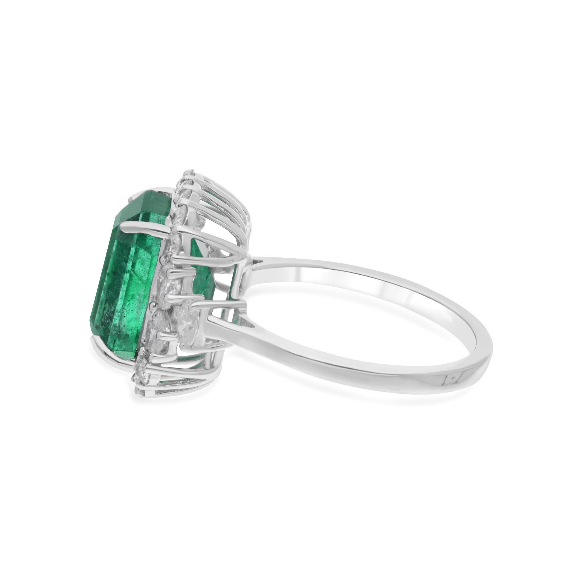 Surrounding the emerald are shimmering diamonds, meticulously set to enhance its beauty and create a mesmerizing display of light. The diamonds add a touch of glamour and sparkle to the design, accentuating the allure of the emerald and elevating