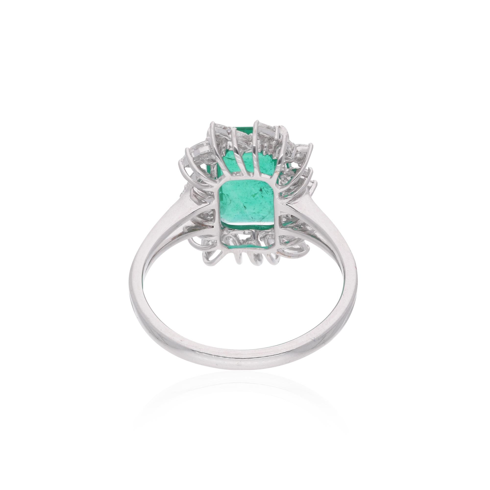 The Zambian emerald, renowned for its exceptional color and clarity, is securely nestled within a setting of lustrous 14 karat white gold, enhancing its natural beauty and brilliance. Surrounding the emerald are dazzling round-cut diamonds,