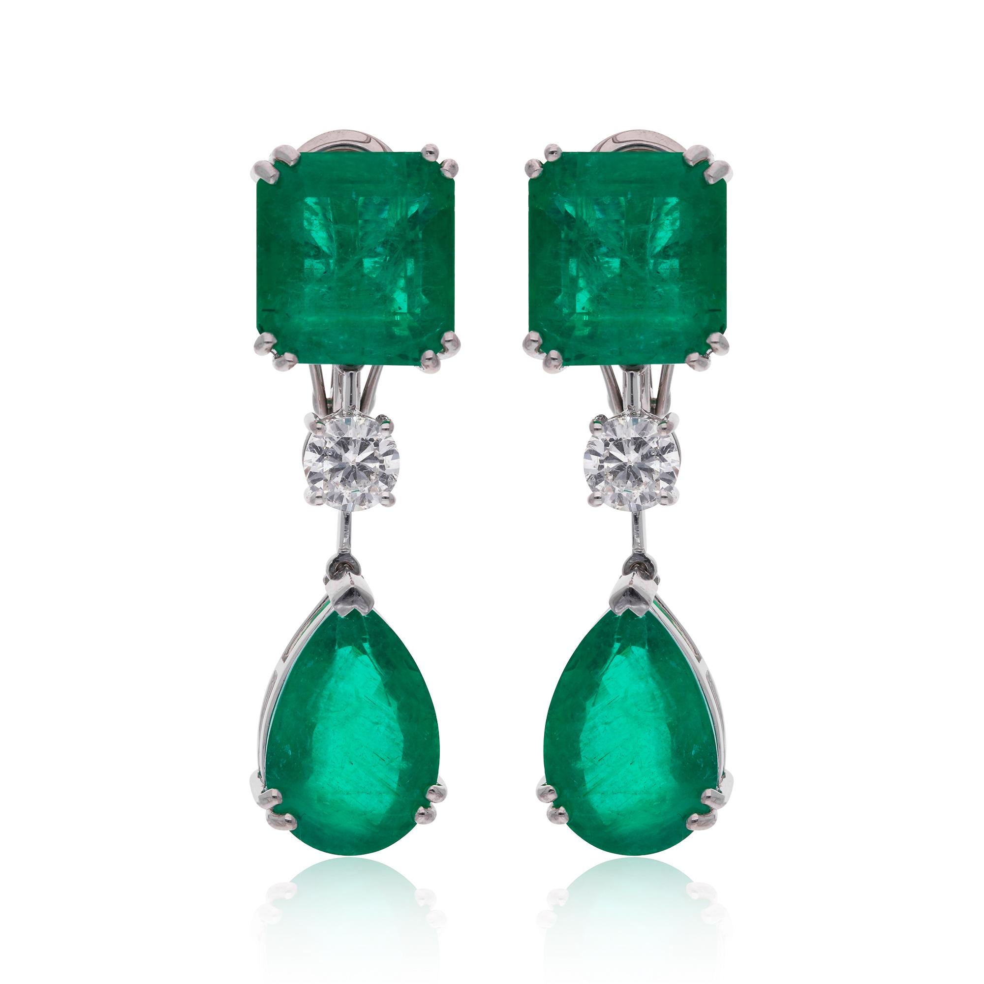 Indulge in the enchanting allure of these Zambian emerald gemstone dangle earrings, adorned with sparkling diamonds and crafted in luxurious 14 karat white gold. Each earring features a captivating Zambian emerald gemstone, renowned for its rich