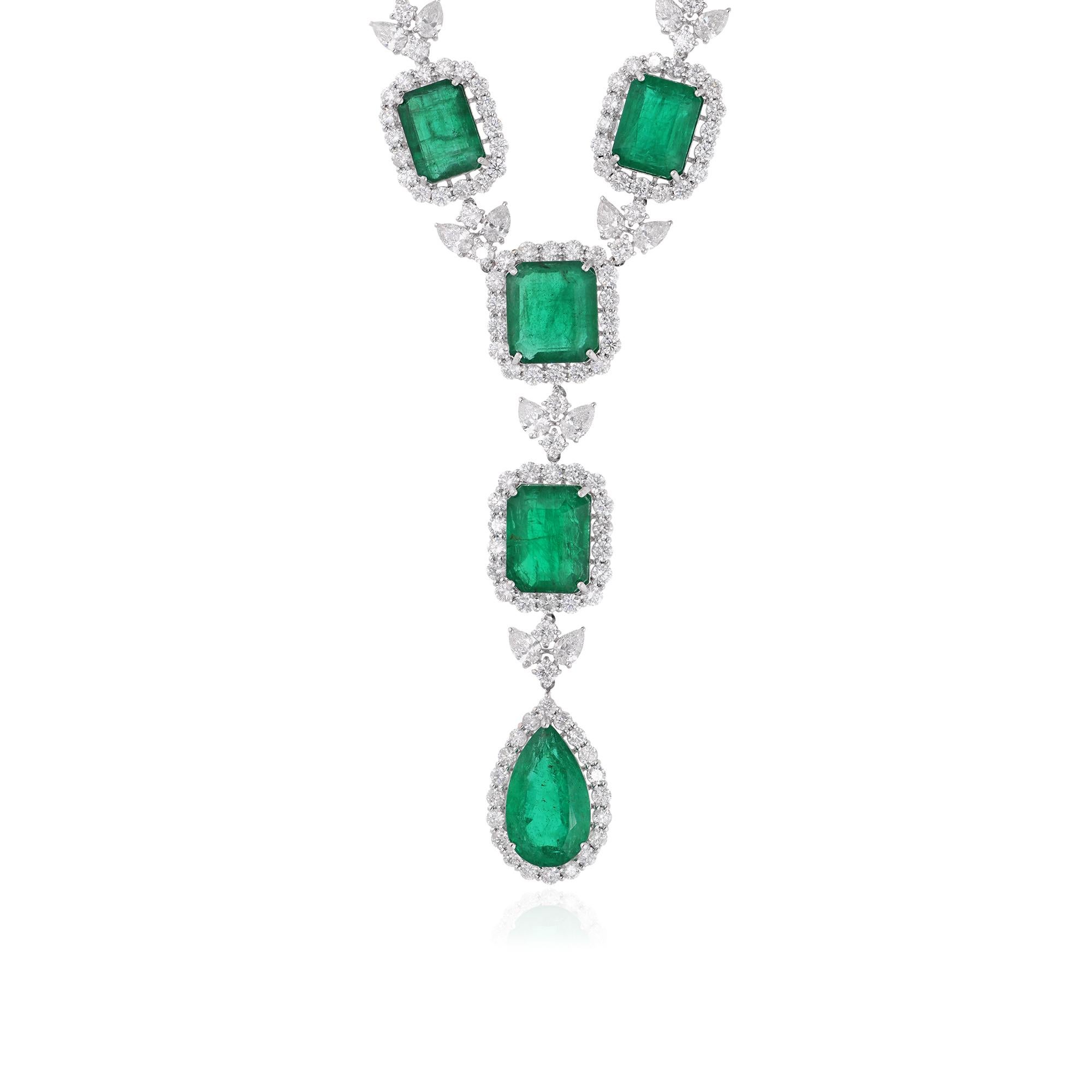 Immerse yourself in the captivating allure of this exquisite Zambian Emerald Gemstone Necklace, adorned with dazzling diamonds and meticulously handcrafted in luminous 14 karat white gold. This stunning piece of handmade jewelry is a true embodiment