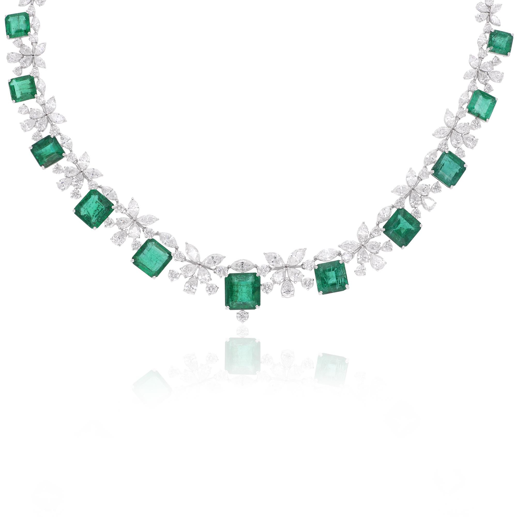 Immerse yourself in the mesmerizing beauty of this Zambian Emerald Gemstone Necklace, intricately handcrafted and adorned with sparkling diamonds, all set in luxurious 18 karat white gold. Every detail of this necklace is a testament to the