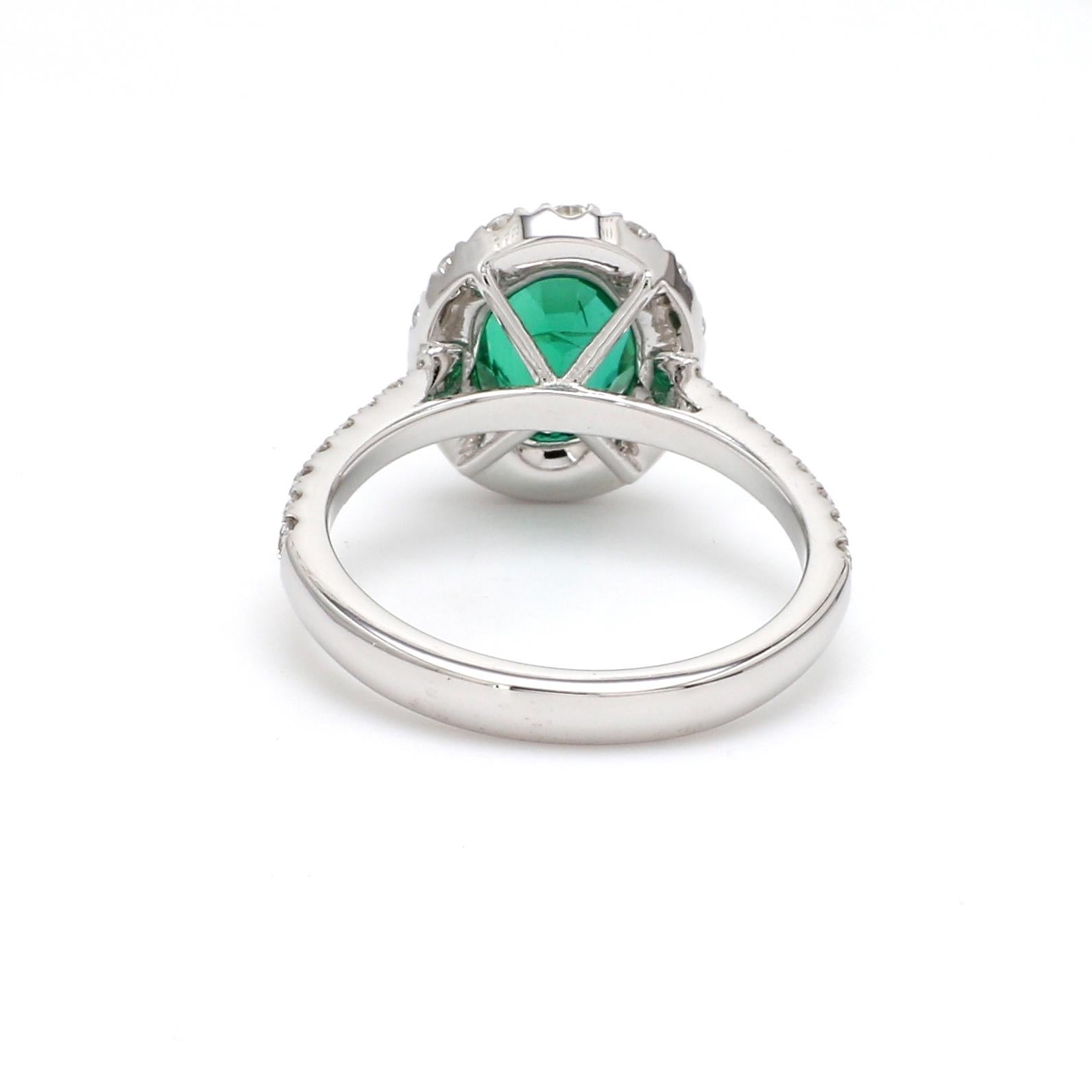 Contemporary 18 Karat White Gold Zambian Emerald Halo Diamond Ring For Sale