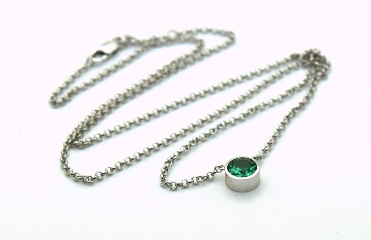 6mm Zambian emerald in modern bezel setting in 18KT white gold, chain is 16-18