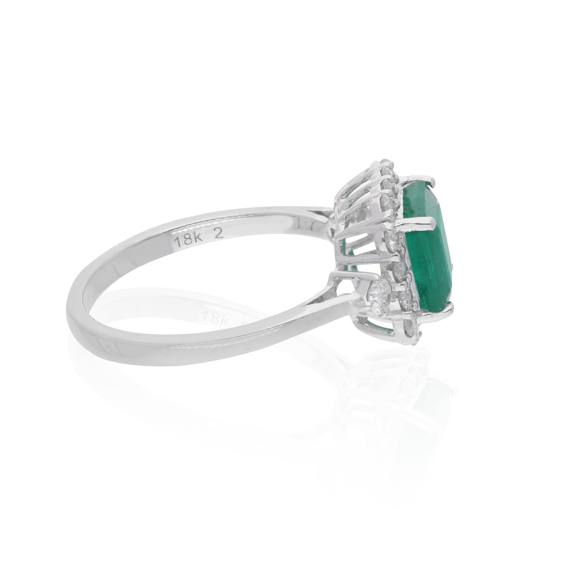 Immerse yourself in the enchanting beauty of this Zambian Emerald Gemstone Ring, an exquisite piece of handmade fine jewelry meticulously crafted in luxurious 18 Karat White Gold. Radiating elegance and sophistication, this ring is adorned with