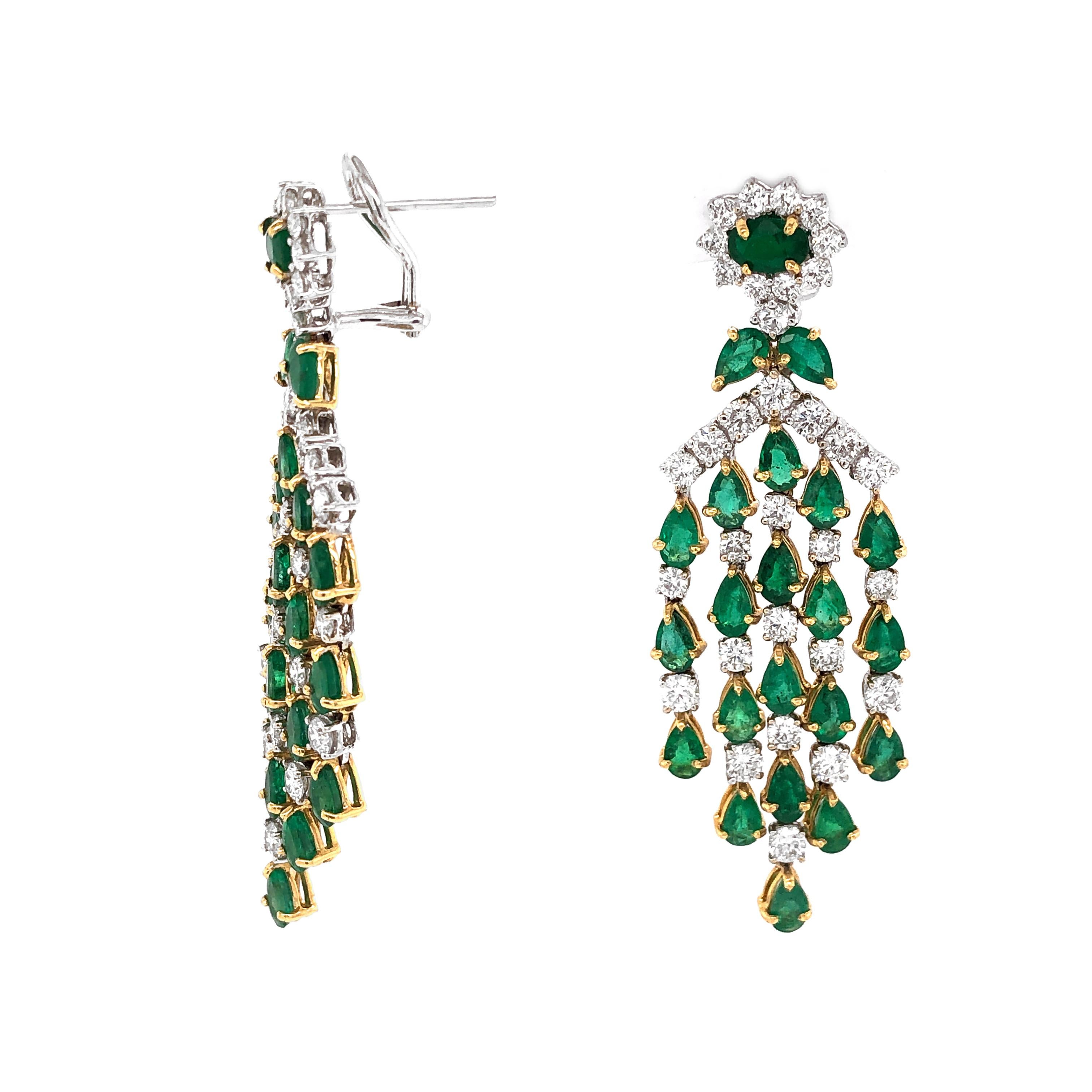 Gorgeous chandelier earrings in 18 Karat gold.
Adorned with Zambian pear cut emeralds in 10.36 carat total. 
Accented by white round diamonds 7.66 carat total.
Diamonds are natural and in G-H Color Clarity VS. 
French / Omega clips.
Vintage and Art