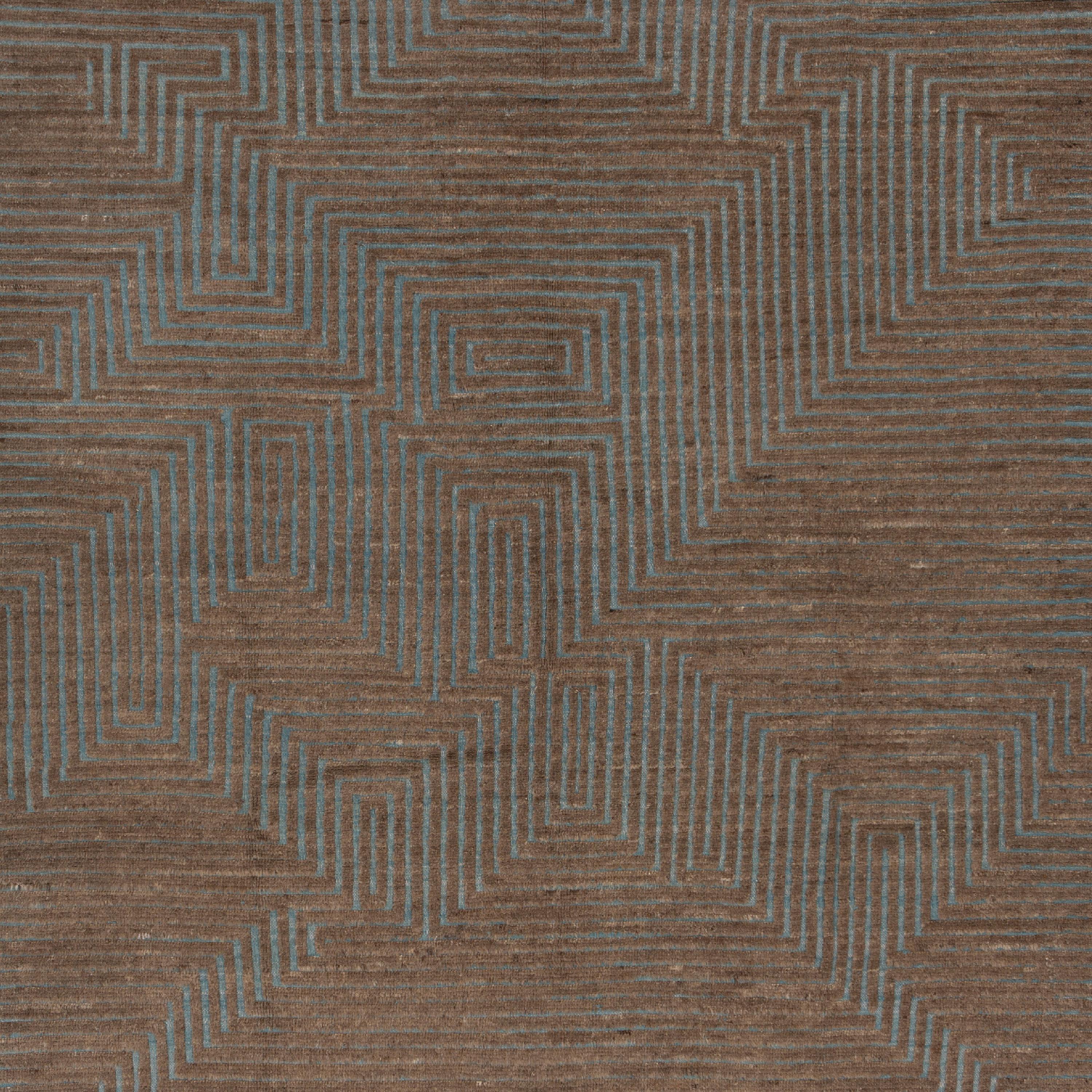 Inspired by the grounding foundations of Earth's natural colors and pure materials, this Zameen Blue and Brown Geometric Wool Rug - 6'5