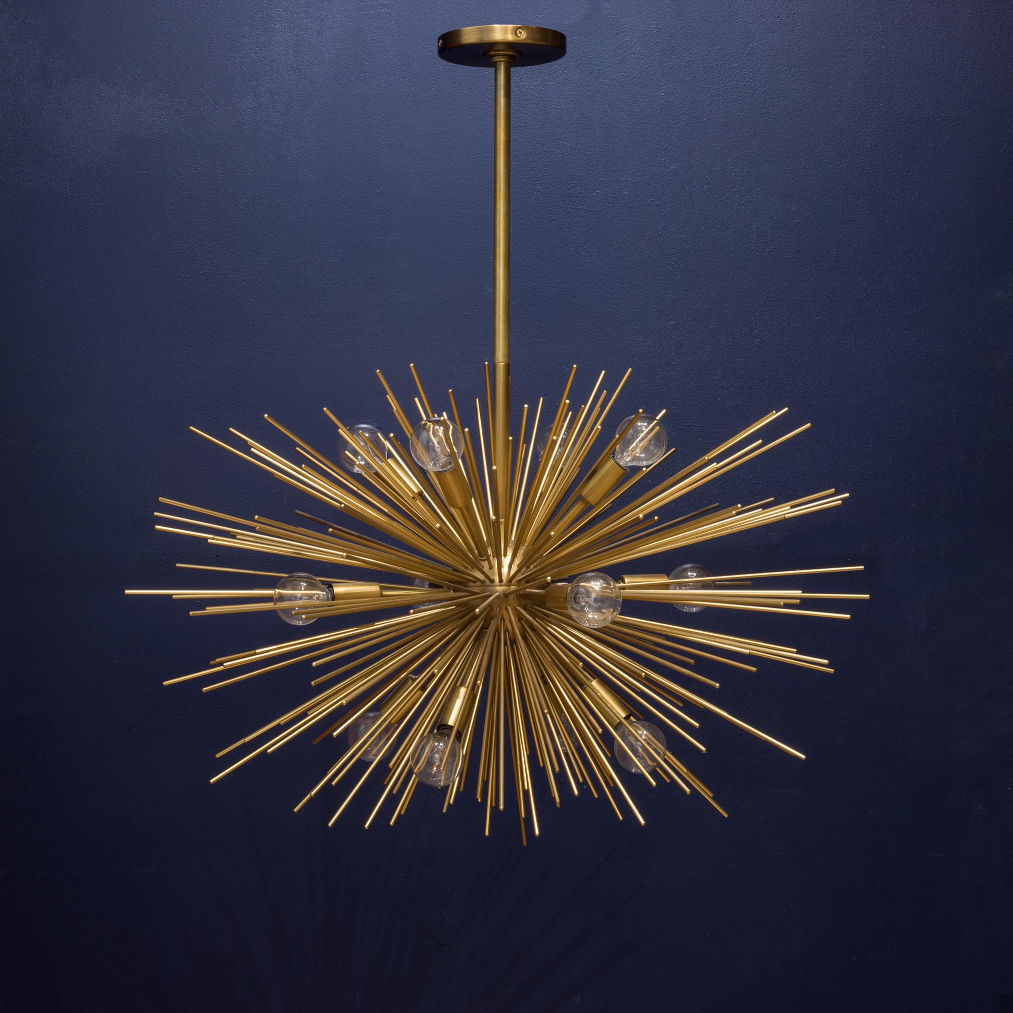 About

Modern sphere shaped starburst motif 12-light iron chandelier in antique brass finish. Includes cylindrical ceiling mount and (1) 6” and (3) 12” rods. The 12