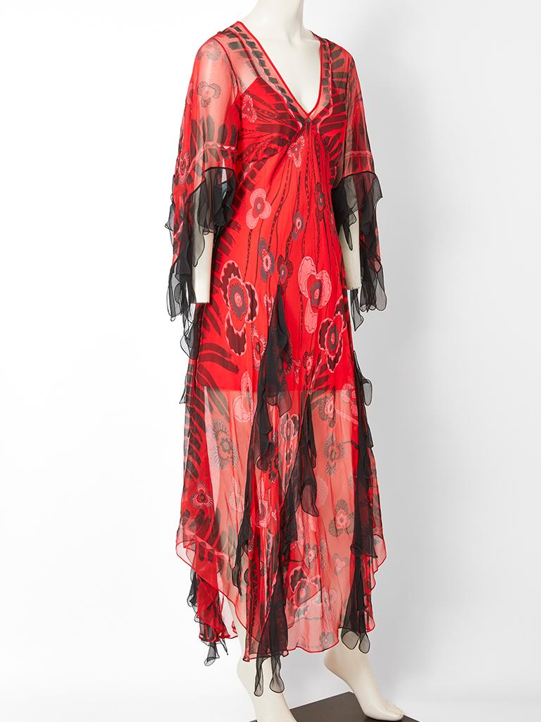 Zandra Rhodes, red chiffon, bohemian style, midi dress with a black iconic Rhodes print. Dress has an empire waist with a deep v neck and bat wing sleeves. Black tulle at the sleeve hem and vertically placed on the dress body adds to the whimsical