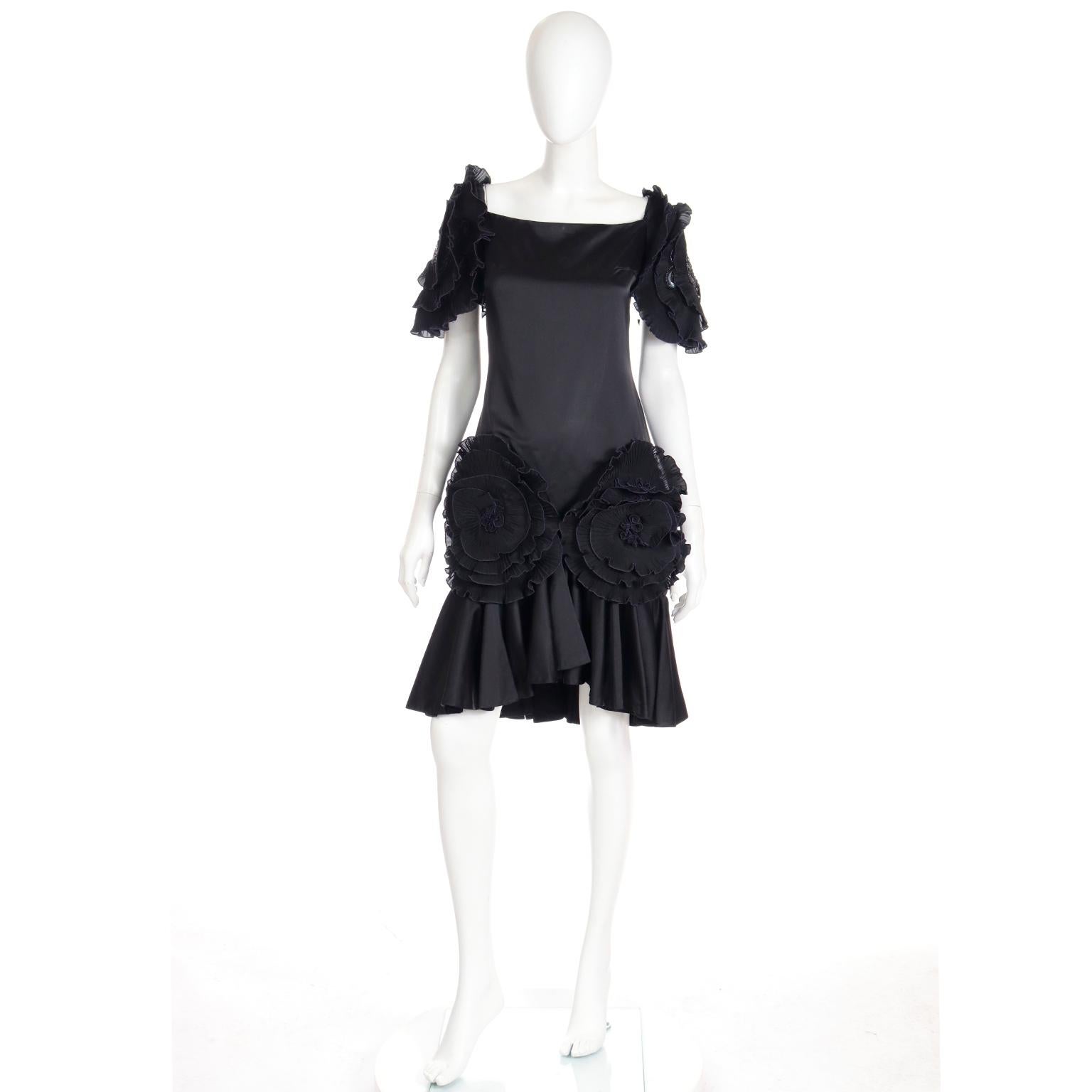 This is an incredible vintage 1980's Zandra Rhodes black satin evening dress with beautiful oversized rosettes at the sleeves and on the skirt. These rosettes are pleated and the ones on the gorgeous sleeves have beads and sequins. Made of 51% silk