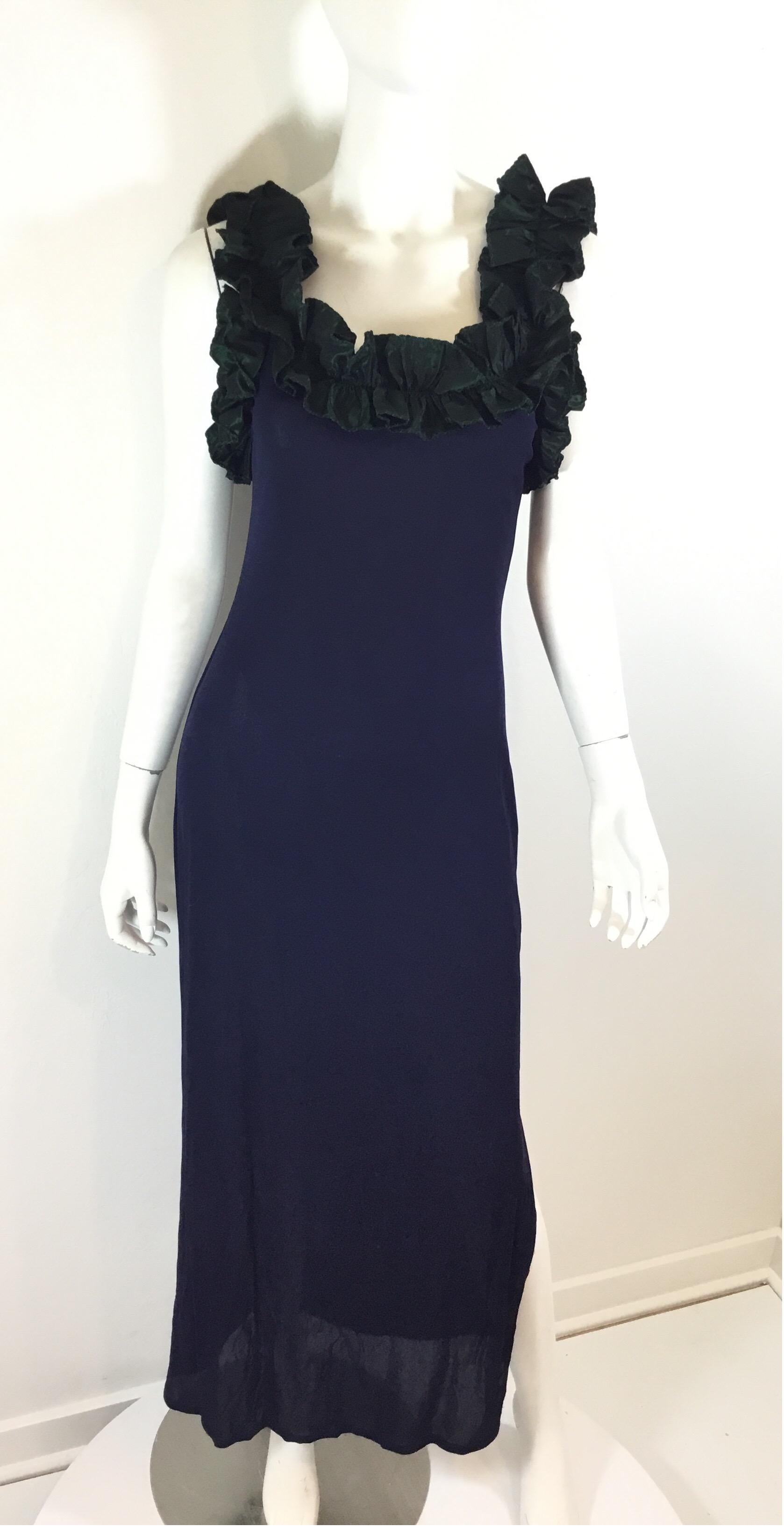 Zandra Rhodes Navy Blue Jersey Dress features a green taffeta ruffled trim along the neckline and a slit along the left leg. Dress is in great vintage condition with normal wears. Labeled Size medium, handmade in England. 

Measurements: bust 30”,
