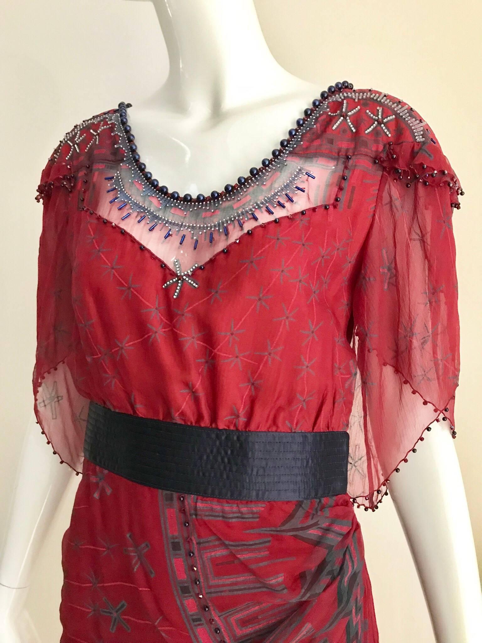 Beautiful vintage Zandra Rhodes red and blue print silk dress embellished with blue pearls on the collar. Fitted at the waist with blue silk band and zipped on the the side. Very flattering fit  Size XS/ 2 
Bust: 34