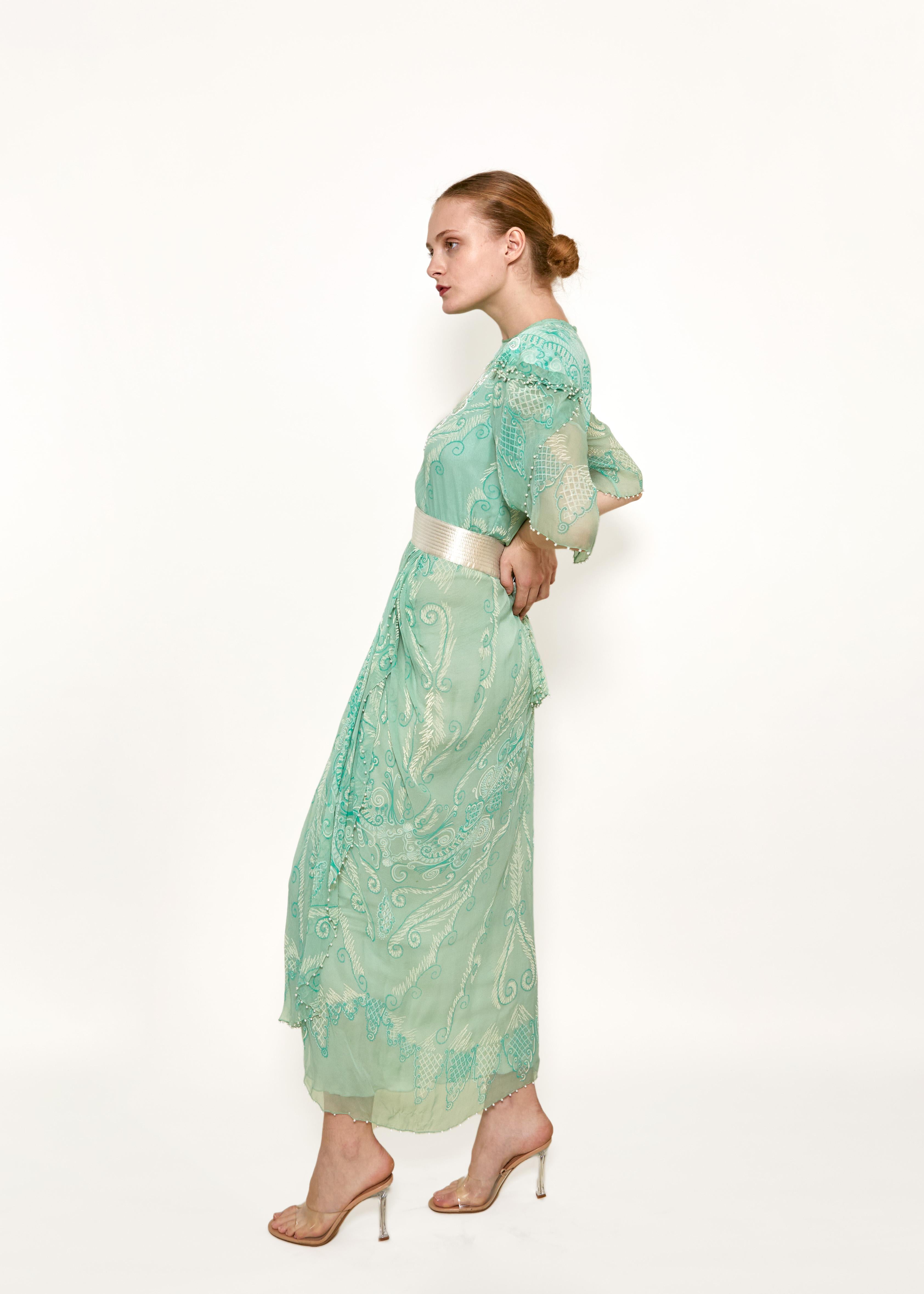 Indulge in luxury with our Zandra Rhodes Mint Green Pearl Trimmed Satin Belt Dress. From her Venetian Splendour S/S 1989 Collection. The pearlescent and embellished details add a touch of elegance to the soft mint green hue. The satin belt cinches