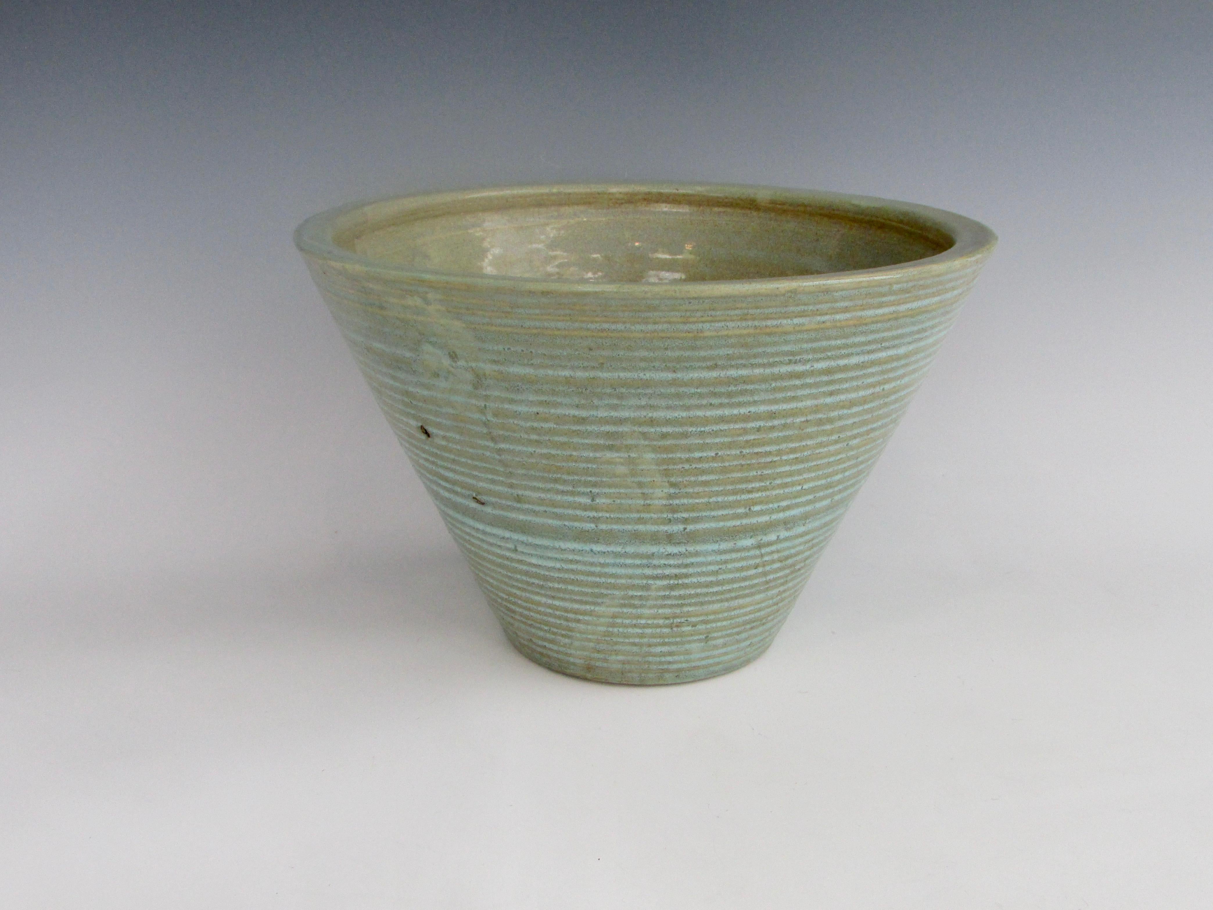 Concentric ring design from top to bottom on this taper cone body planter pot .  Part of the Homespun line by Zanesville Pottery Ohio.
