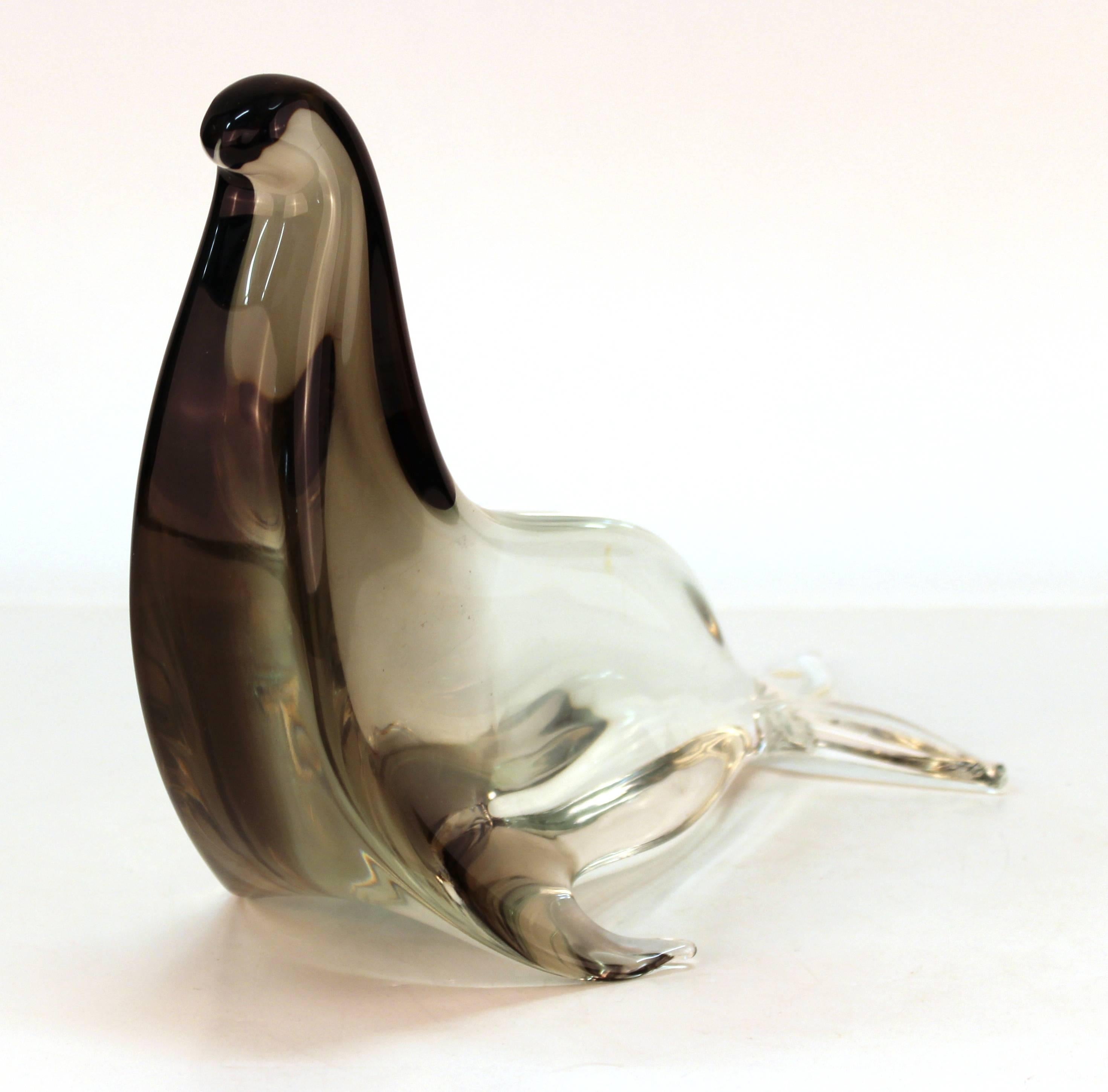 A Mid-Century Modern Italian art glass sculpture in shape of a seal, made by Licio Zanetti in partially smoked glass. The piece is signed on the bottom and is in great vintage condition.