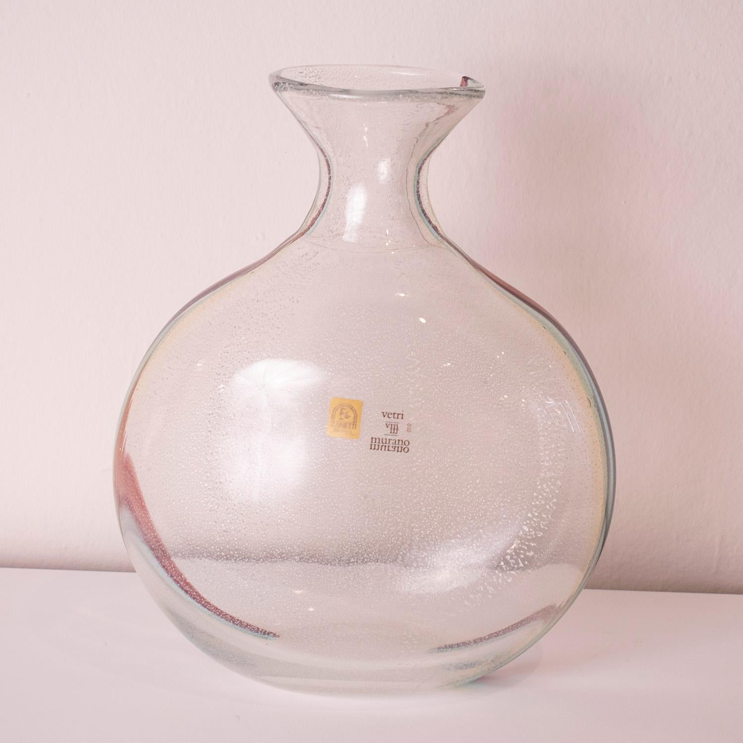 This stylish vase was realized in Murano, Italy- the island off the coast of Venice renowned for centuries for its superlative glass production- circa 1970 by the esteemed studio Licio Zanetti. Realized in handblown translucent Murano glass and
