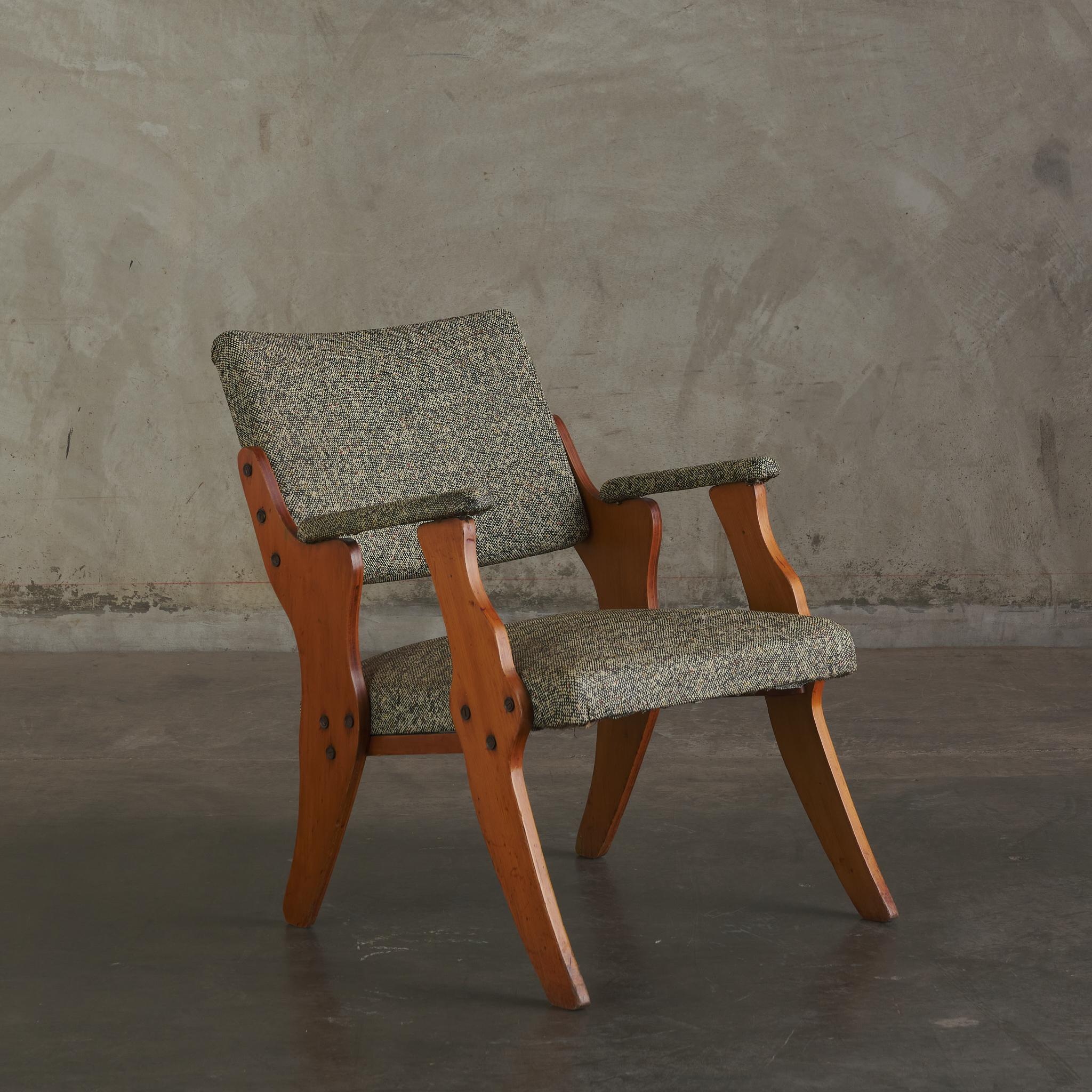 A mixture of modernity and craftsmanship, this mid century chair, in wood and wool, is comfortable in a corner or on its own as a centerpiece.