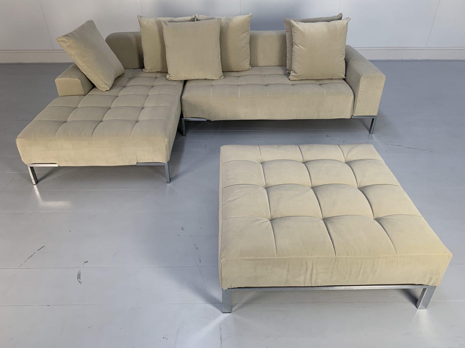 This is a rare, pristine “Alfa 1326” L-Shape 4-Seat Sofa & Ottoman from the world renown Italian furniture house of Zanotta, dressed in their top-grade modern, short-pile velvet in pale-grey, supplied with numerous scatter-cushions, and with