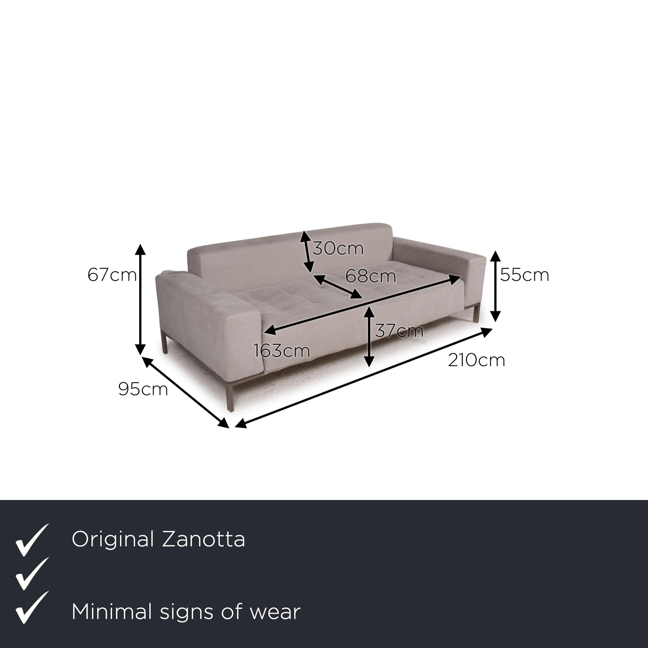 We present to you a Zanotta Alfa fabric sofa gray two-seater couch.

Product measurements in centimeters:

depth: 95
width: 210
height: 67
seat height: 37
rest height: 55
seat depth: 68
seat width: 163
back height: 30.

 
