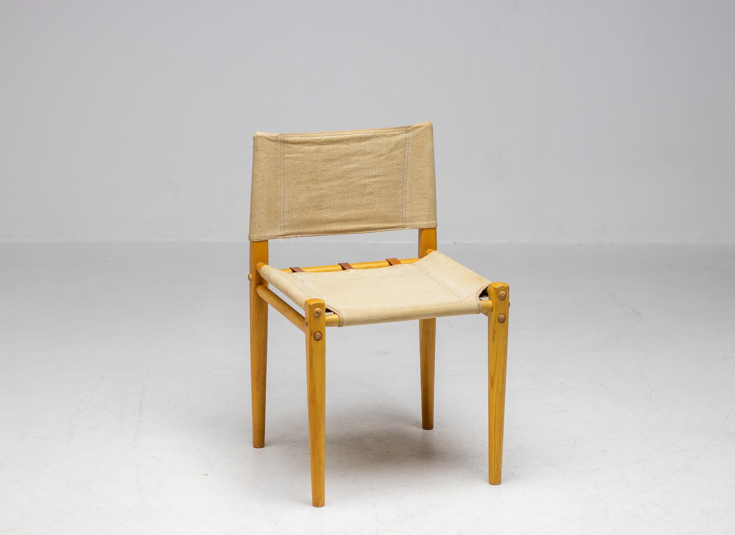 Rare 1970s side chair in ash and canvas made by Zanotta. The chair is very solid but disassembles completely when desired.  In wonderful vintage condition, one of the 3 leather belts in the seat has been replaced as shown in one of the