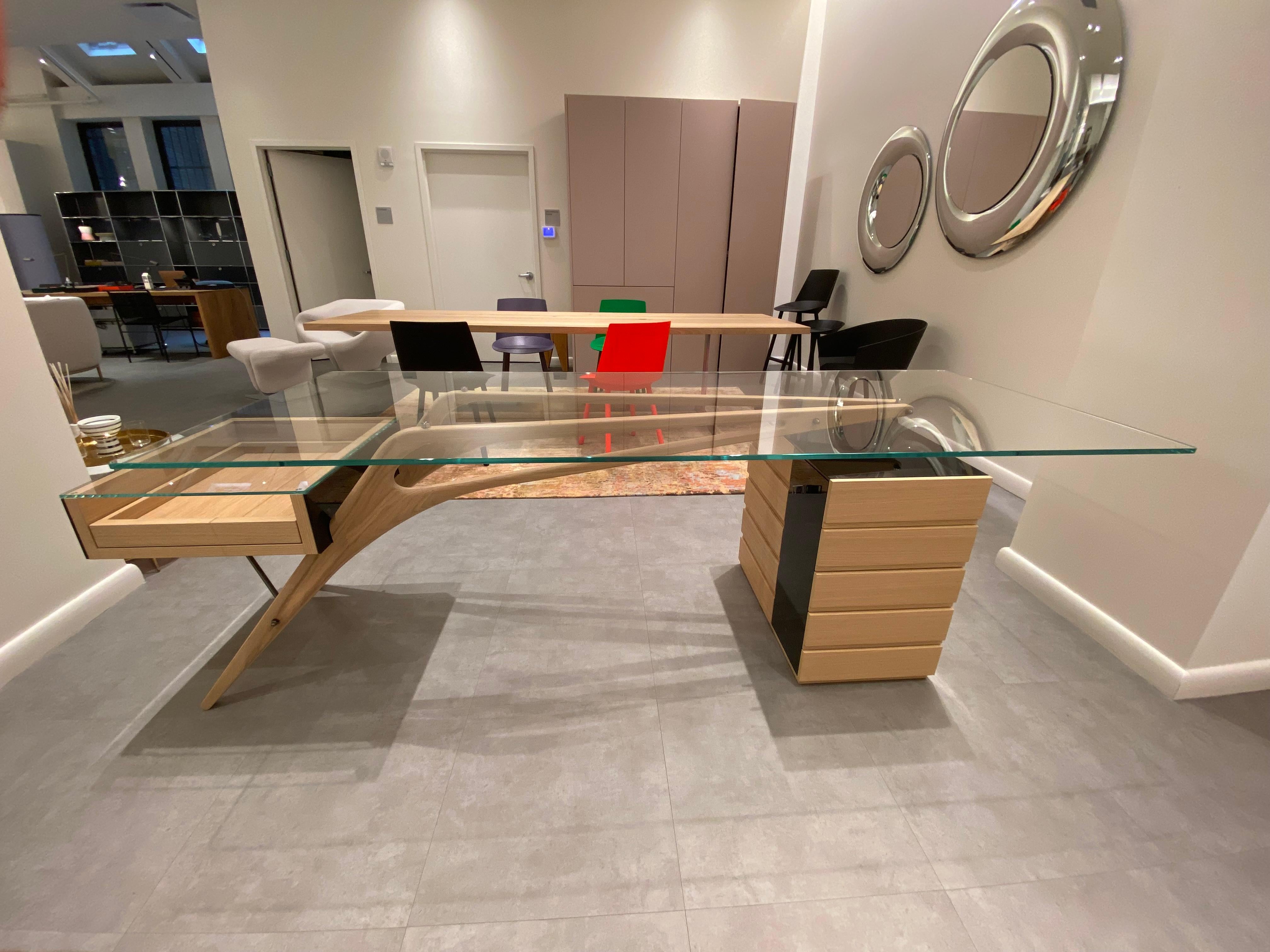 Writing desk. Legs in solid natural oak, Extractable open tray and drawer element both covered with 8 mm thick extra-clear tempered plate glass, back-painted in black. 12mm thick extra clear plate glass top.