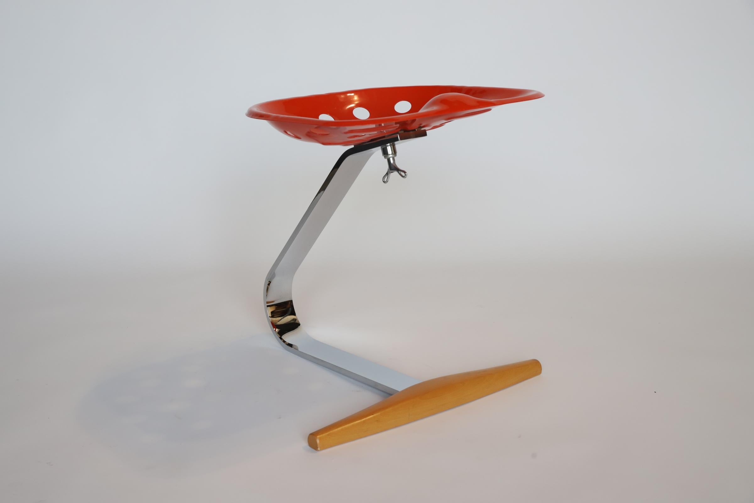 Modern, Italian Mezzadro “tractor” stool by Achille Castiglioni. Originally designed in the 1950s, this simple, but iconic stool consists of a tractor seat, bent flat bar steel and wood. Retains manufacturer stamp, as well as, ‘Made in Italy’ on
