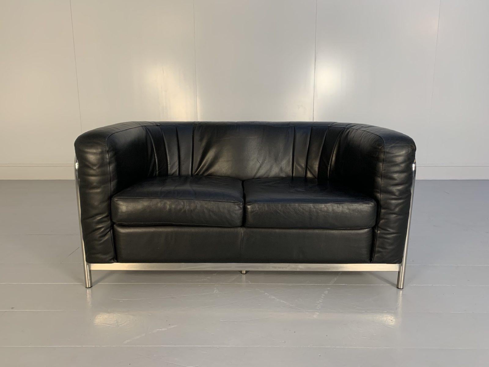 On offer on this occasion is a rare, immaculately presented “Onda” 2-Seat Sofa from the world renown Italian furniture house of Zanotta, dressed in their legendary, incomparable “Scozia” Leather in Jet-Black, and with a polished-chrome frame.
As you