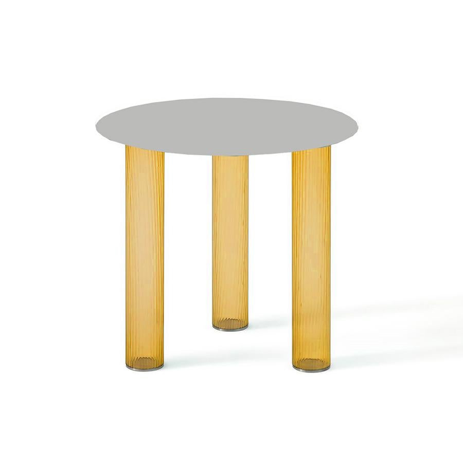 Small tables. Three-layered blown glass legs in amber and blue. Sebastian Herkner, renowned for his particular sensitivity toward glass, designed a pair of small tables where the glass strength and durability are axiomatically used for developing