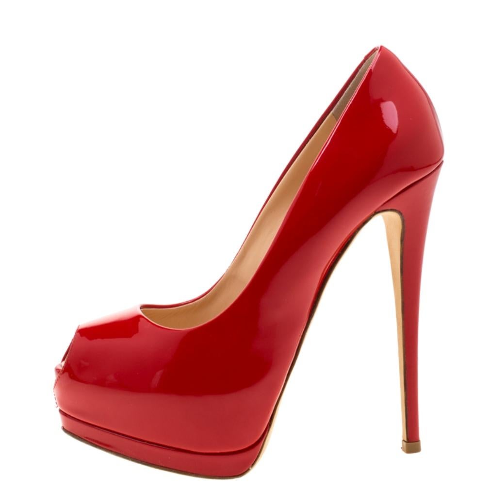 These one of a kind Zanotti Peep Toe Platform pumps are just ideal for the ultra-chic fashionista. The eye-catching red colour lend a glam look to these patent leather pumps making them a must-have.

Includes: Original Dustbag

