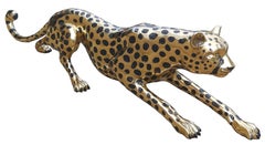 Golden cheetah stalking sculpture