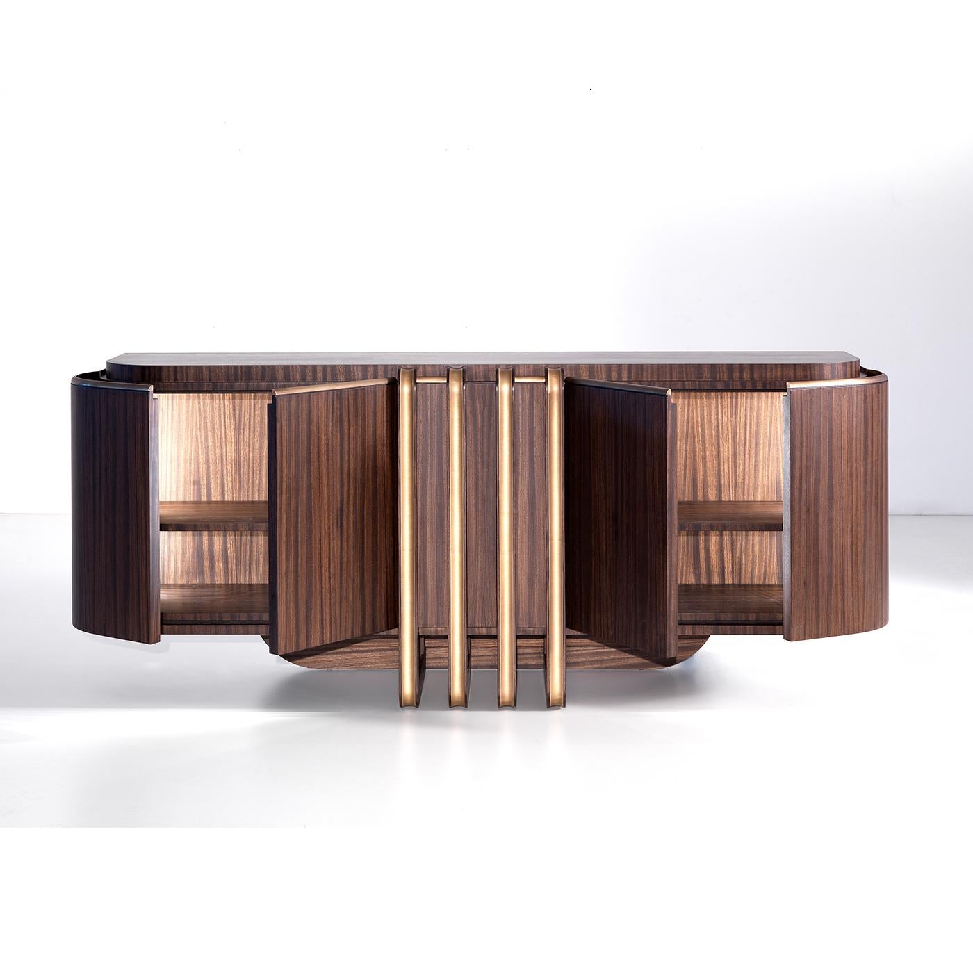 A refined and bold flair marks this eye-catching sideboard crafted of prized zebra wood. Its imposing frame is distinguished for blunted corners and smooth surfaces extremely pleasant to the touch. Streamlined details in solid brass run in parallel