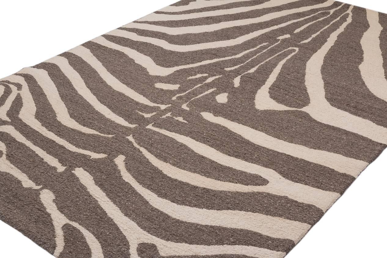 This contemporary zebra carpet design is an original by Joseph Carini. Handwoven using a brocade weave and natural unbleached white and grey wool from the high Himalayan plateau. Measures: 6 x 9.